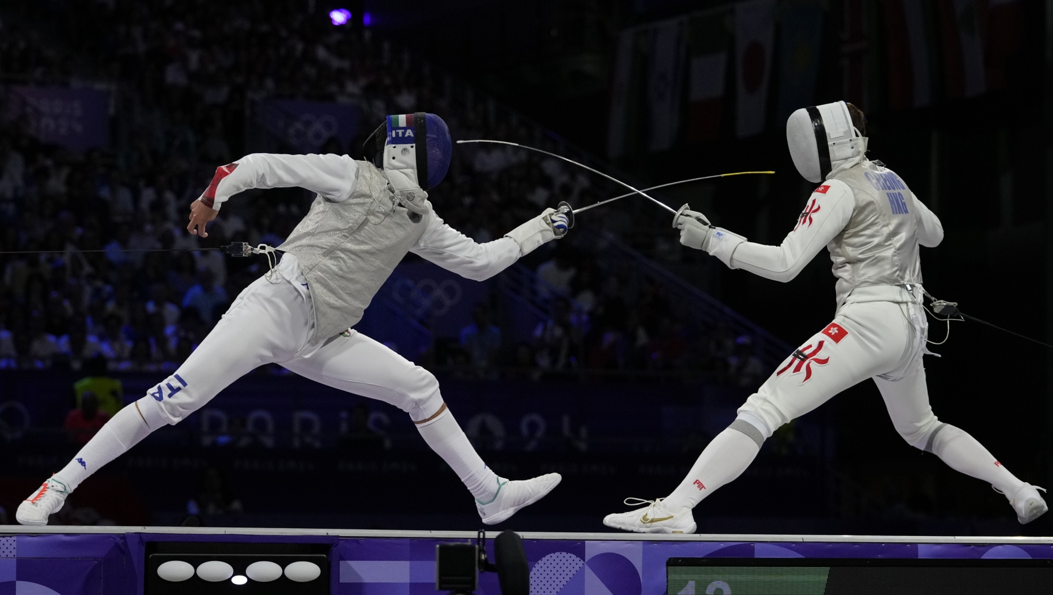Hong Kong's Cheung Ka long, right, competes with Italy's Filippo Macchi in the men's individual Foil final match during the 2024 Summer Olympics at the Grand Palais, Monday, July 29, 2024, in Paris, France. (AP Photo/Andrew Medichini)