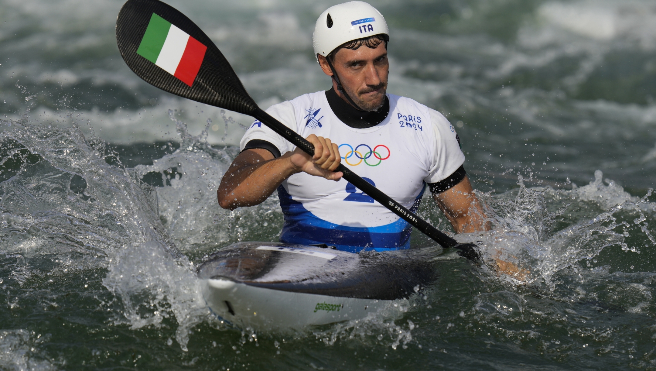 Giovanni de Gennaro of Italy competes in the men's kayak single heats at the 2024 Summer Olympics, Tuesday, July 30, 2024, in Vaires-sur-Marne, France. (AP Photo/Kirsty Wigglesworth)