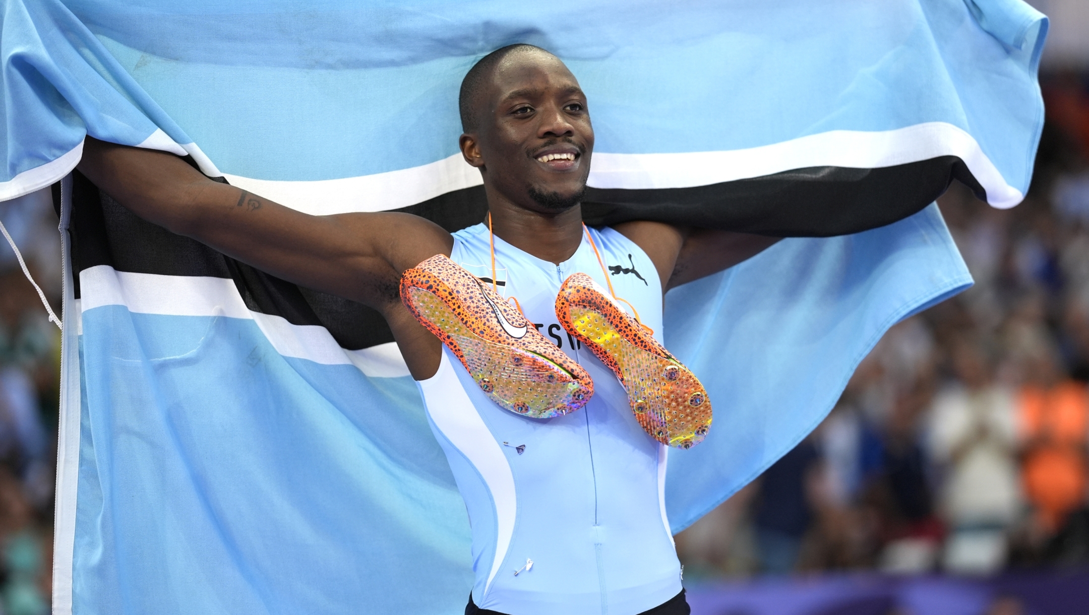 Letsile Tebogo, of Botswana, celebrates after winning the men's 200-meter final at the 2024 Summer Olympics, Thursday, Aug. 8, 2024, in Saint-Denis, France. (AP Photo/Matthias Schrader)