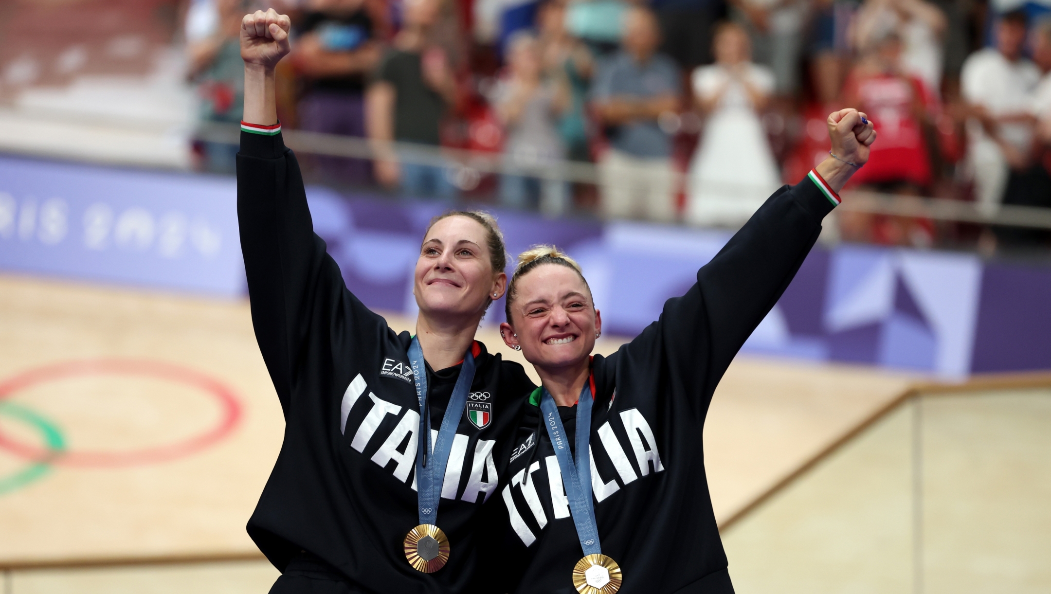 PARIS, FRANCE - AUGUST 09: (L-R) Gold medalists Vittoria Guazzini and Chiara Consonni of Team Italy celebrate at podium after the Women's Madison Final on day fourteen of the Olympic Games Paris 2024 at Saint-Quentin-en-Yvelines Velodrome on August 09, 2024 in Paris, France. (Photo by Tim de Waele/Getty Images)