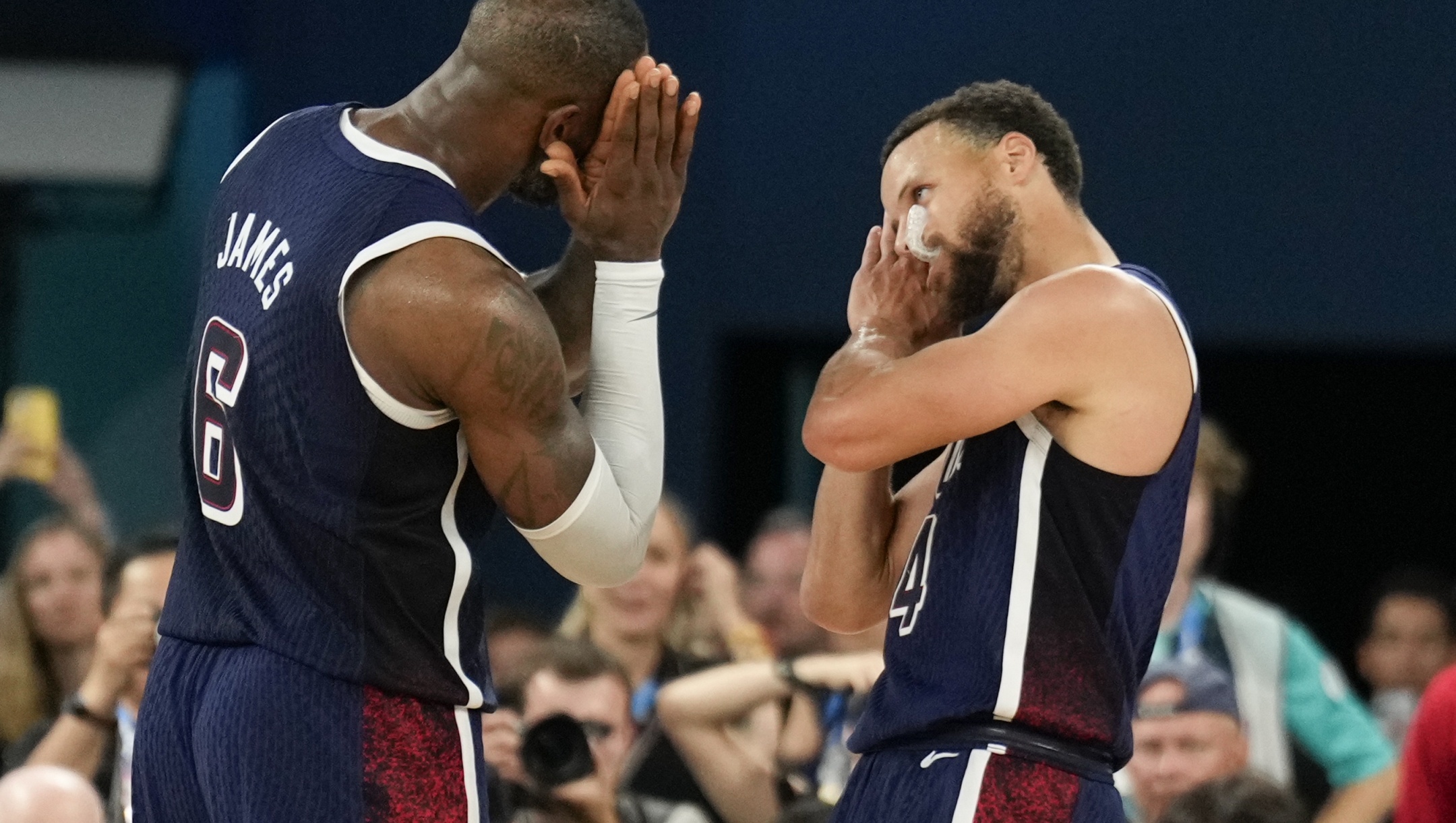 United States' Stephen Curry (4) and LeBron James (6) celebrate after beating France to win the gold medal during a men's gold medal basketball game at Bercy Arena at the 2024 Summer Olympics, Saturday, Aug. 10, 2024, in Paris, France. (AP Photo/Mark J. Terrill)