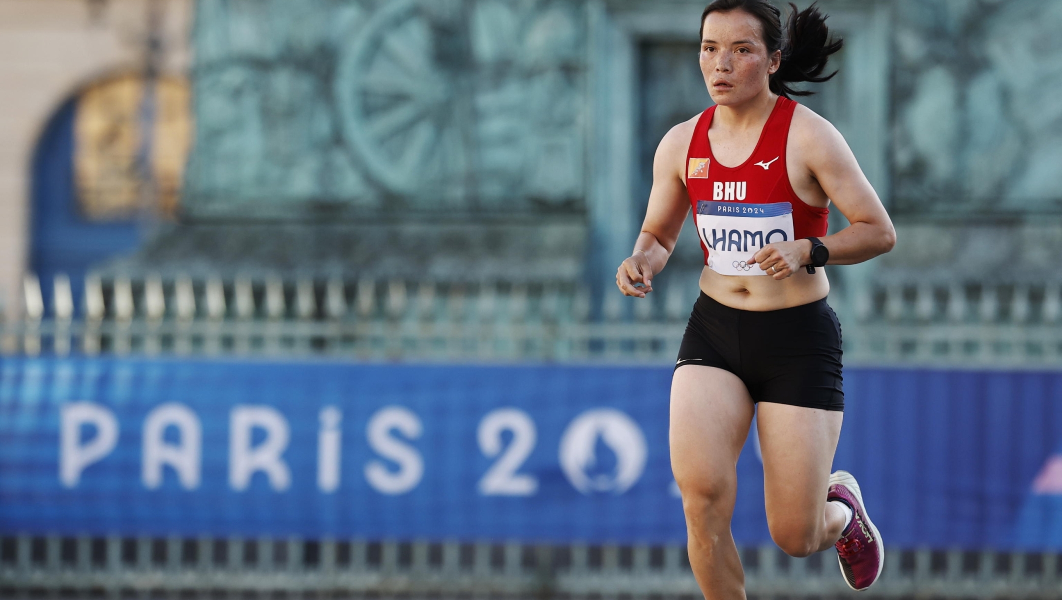 epa11544458 Kinzang Lhamo of Bhutan competes at the Place Vendome during the Women's Marathon event of the Athletics competitions in the Paris 2024 Olympic Games in Paris, France, 11 August 2024.  EPA/YOAN VALAT