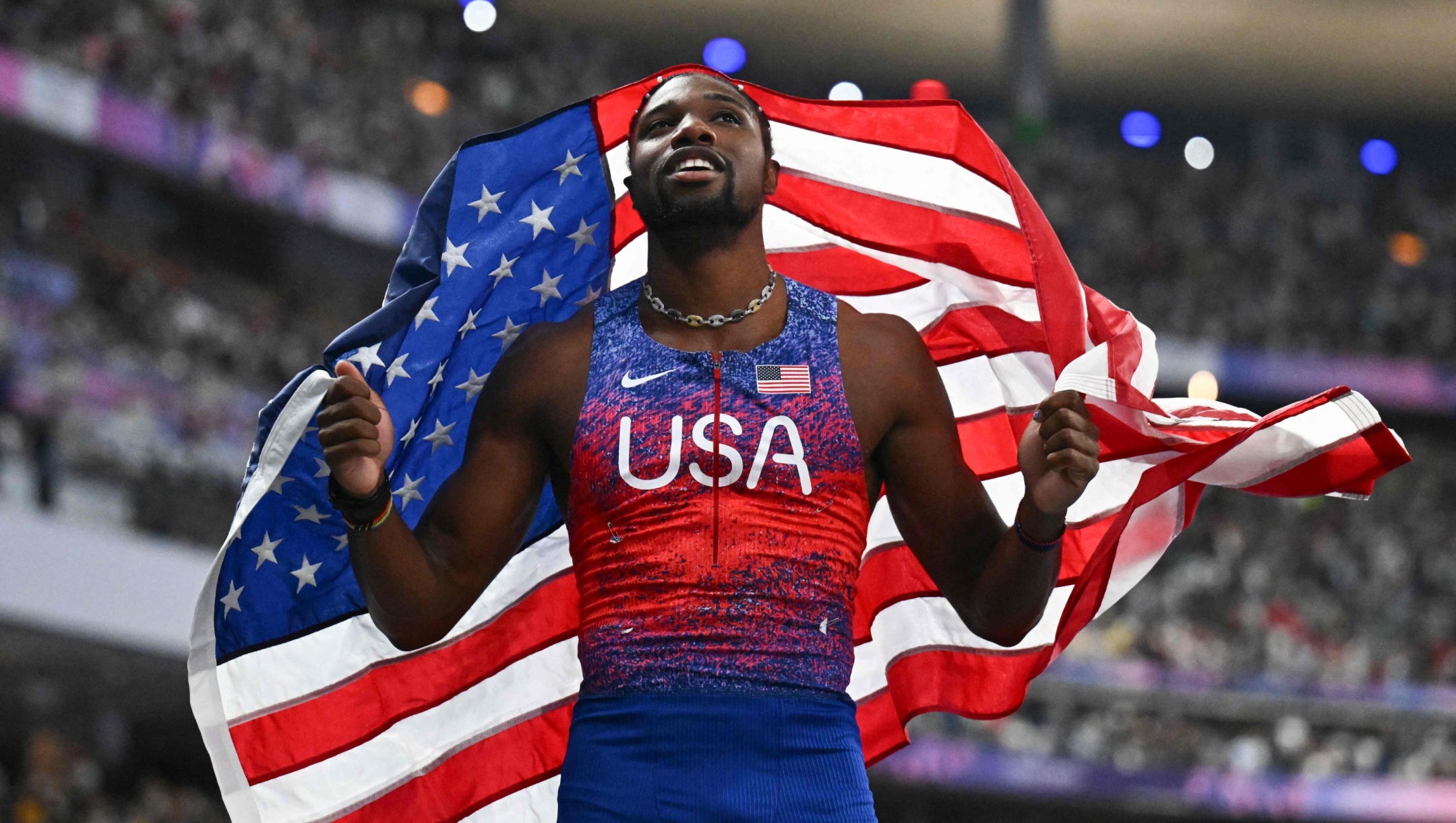 US' Noah Lyles celebrates after winning the men's 100m final of the athletics event at the Paris 2024 Olympic Games at Stade de France in Saint-Denis, north of Paris, on August 4, 2024. (Photo by Jewel SAMAD / AFP)