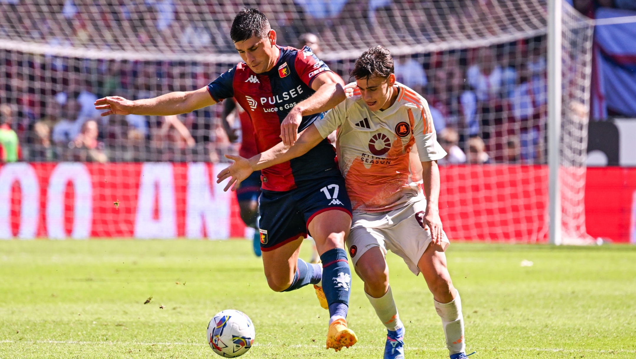 Genoa?s Ruslan Malinovskyi fights for the ball with Roma?s Niccolo Pisilli during the Serie A soccer match between Genoa and Roma at the Luigi Ferraris Stadium in Genoa, Italy - Sunday, September 15, 2024. Sport - Soccer . (Photo by Tano Pecoraro/Lapresse)