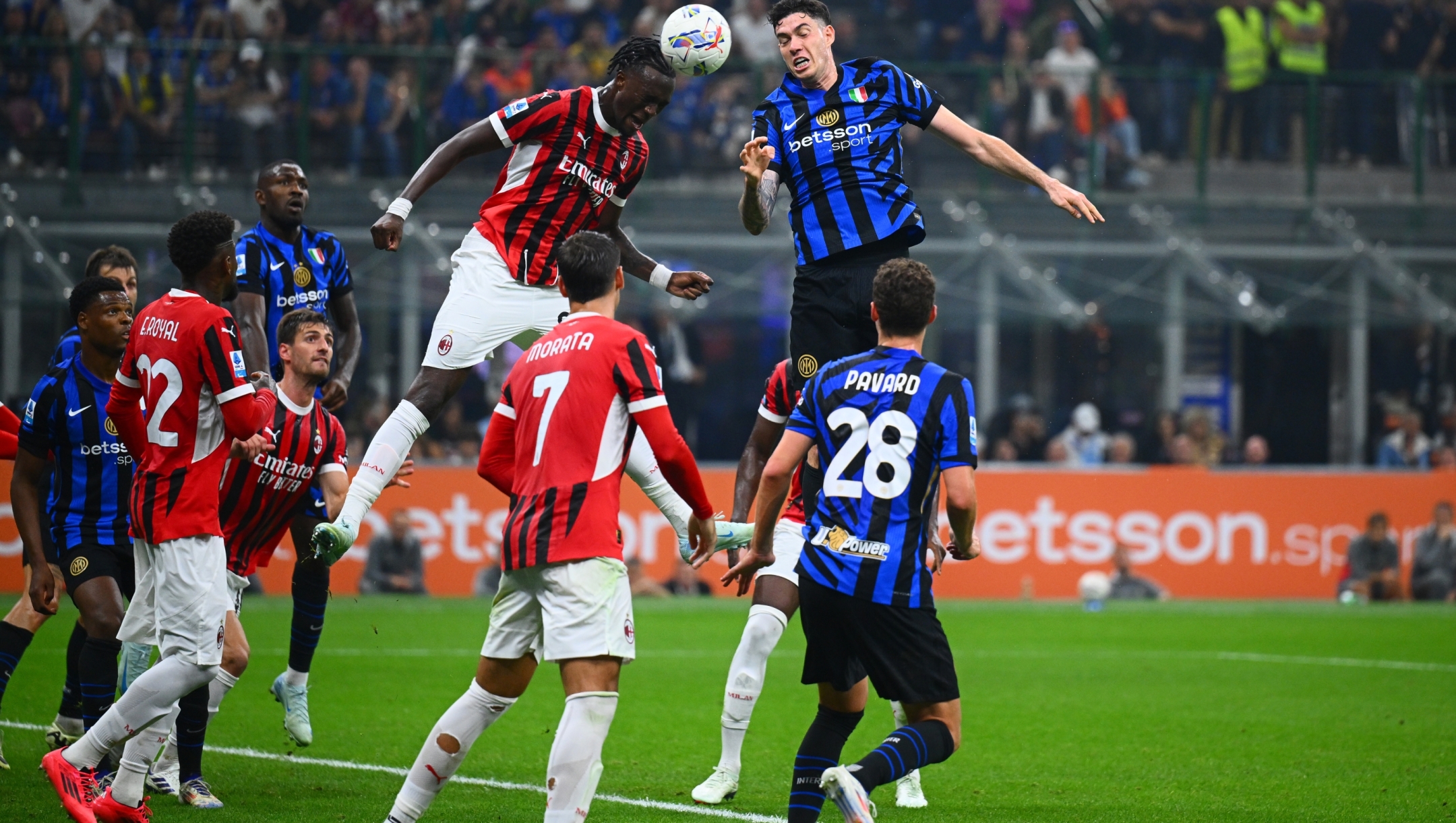 MILAN, ITALY - SEPTEMBER 22: Alessandro Bastoni of FC Internazionale in action, jumps for the ball against Tammy Abraham of AC Milan during the Serie A match between FC Internazionale and AC Milan at Stadio Giuseppe Meazza on September 22, 2024 in Milan, Italy. (Photo by Mattia Pistoia - Inter/Inter via Getty Images)