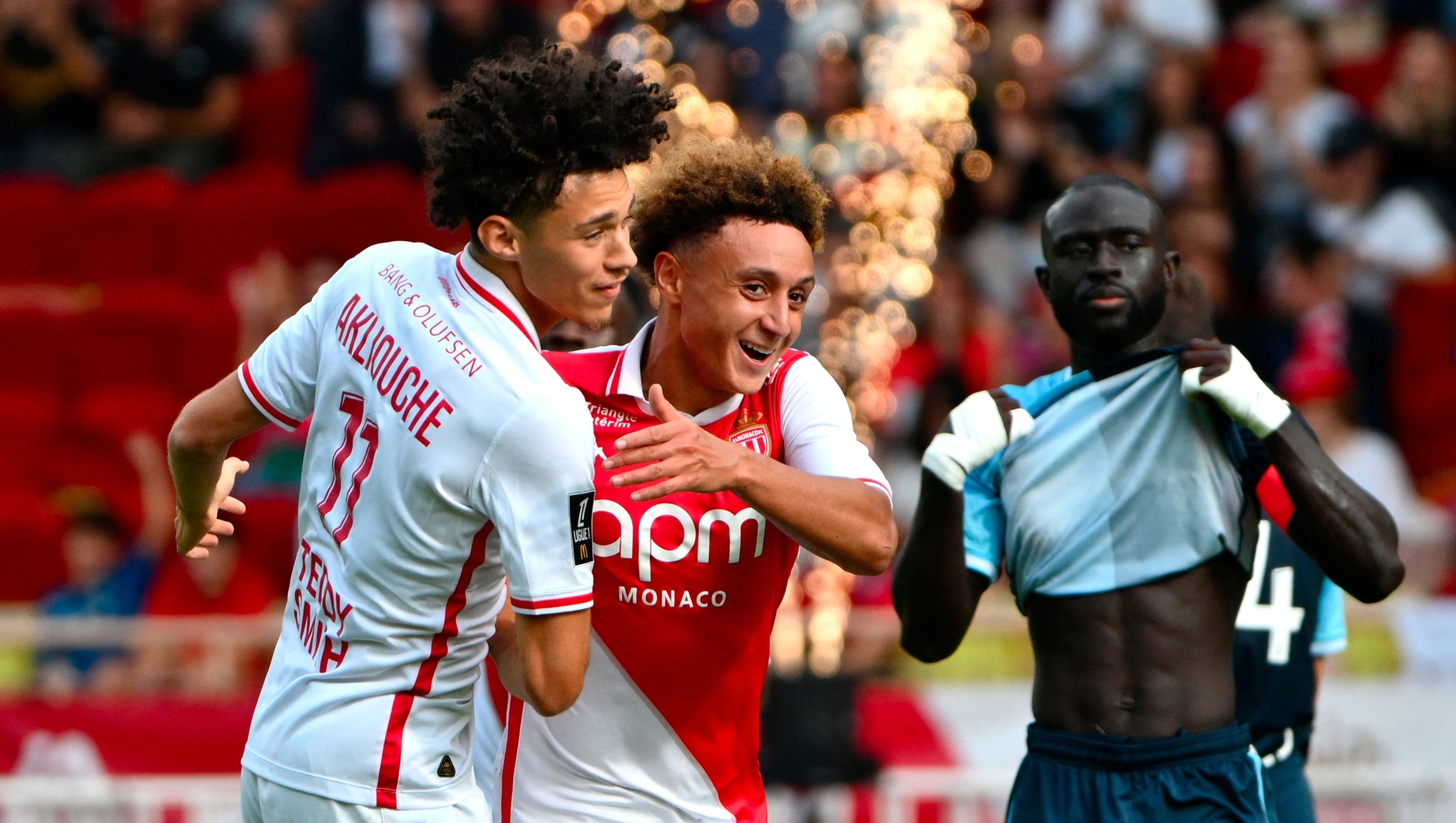 Monaco's French Moroccan midfielder #07 Eliesse Ben Seghir (C) celebrates scoring his team's second goal with Monaco's French midfielder #11 Maghnes Akliouche (L) during the French L1 football match between AS Monaco and Le Havre AC at the Louis II Stadium (Stade Louis II) in the Principality of Monaco on September 22, 2024. (Photo by Christophe SIMON / AFP)