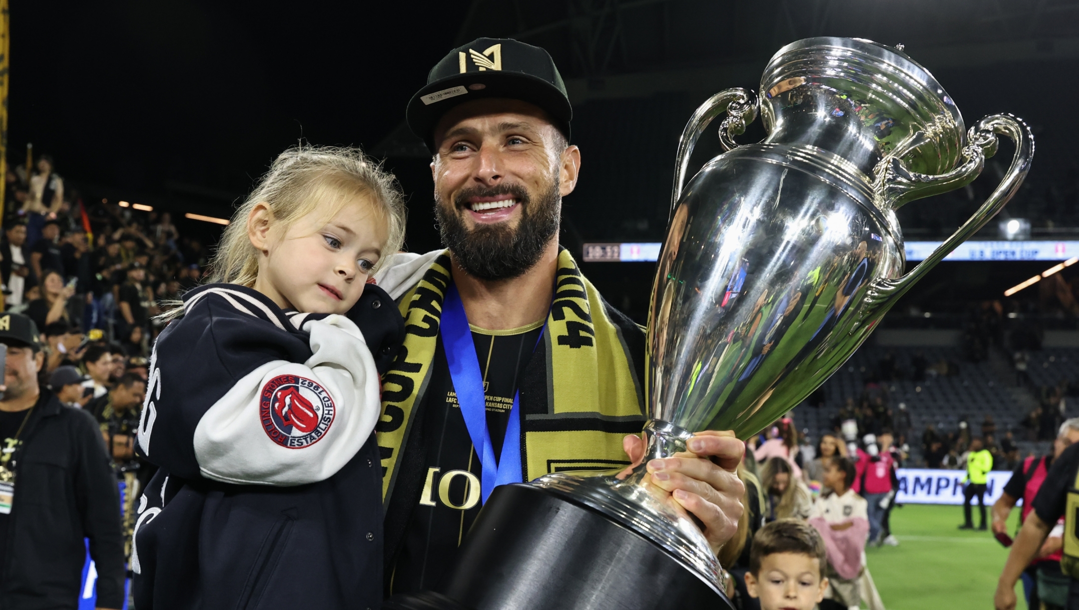 LOS ANGELES, CALIFORNIA - SEPTEMBER 25: Oliver Giroud #9 of Los Angeles FC hoisting the trophy celebrating win over Sporting Kansas City in the finals of the 2024 Lamar Hunt U. S. Open Cup at BMO Stadium on September 25, 2024 in Los Angeles, California.  (Photo by Michael Owens/USSF/Getty Images for USSF)