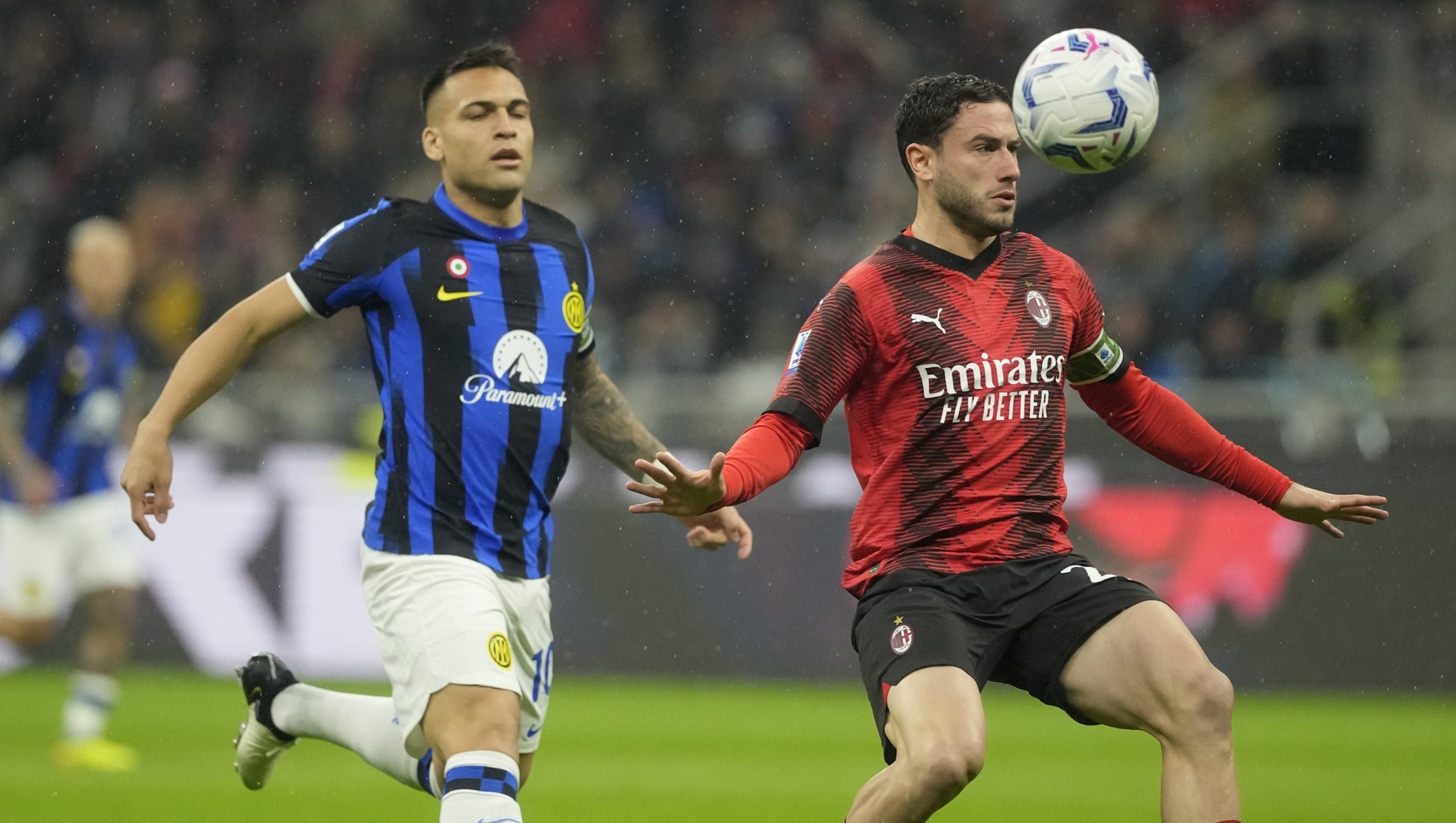 AC Milan's Davide Calabria, right, is challenged by Inter Milan's Lautaro Martinez during a Serie A soccer match between AC Milan and Inter Milan at the San Siro stadium in Milan, Italy, Monday, April 22, 2024. (AP Photo/Luca Bruno)