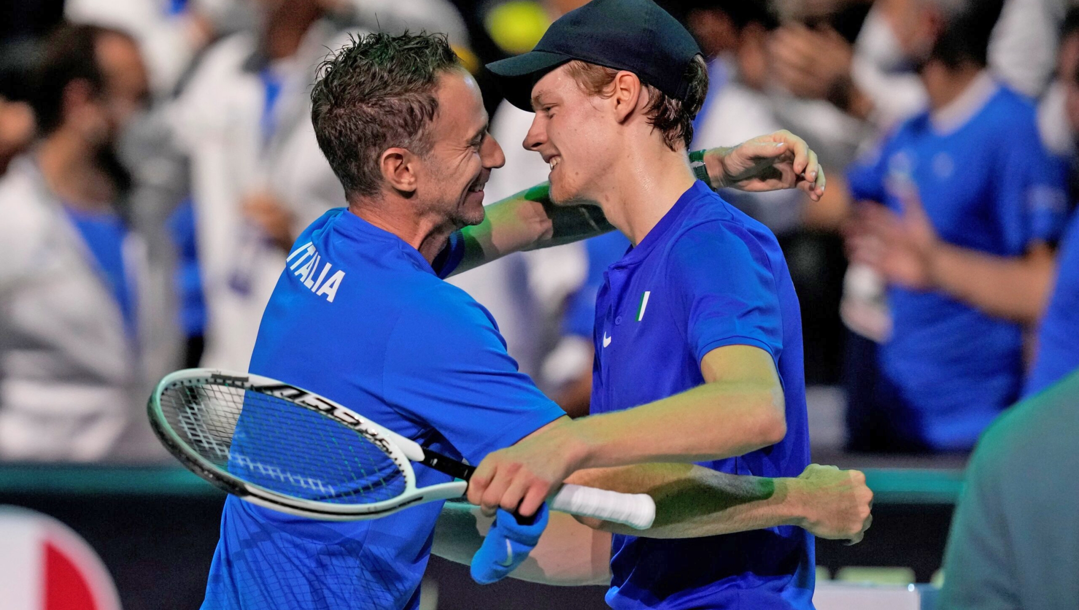 Italy's Jannik Sinner, right, celebrates with his captain Filippo Volandri after winning against Colombia's Daniel Elahi Galan during their Davis Cup men's single Finals tennis match at the Pala Alpitour in Turin, Italy, Sunday, Nov. 28, 2021. (AP Photo/Antonio Calanni)