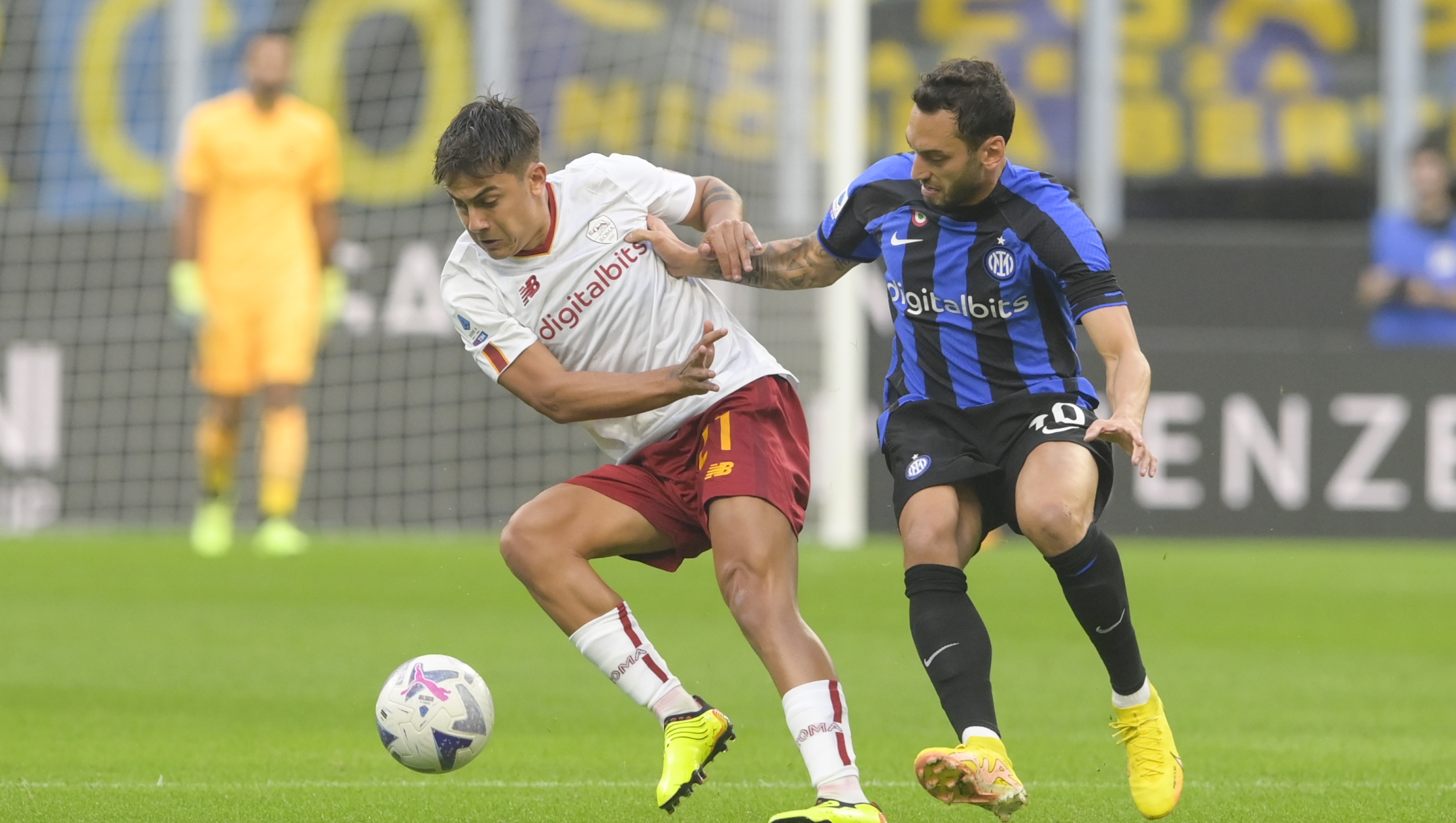 MILAN, ITALY - OCTOBER 01: Paulo Dybala of AS Roma is challenged by Hakan Calhanoglu of FC Internazionale during the Serie A match between FC Internazionale and AS Roma at Stadio Giuseppe Meazza on October 01, 2022 in Milan, Italy. (Photo by Fabio Rossi/AS Roma via Getty Images)