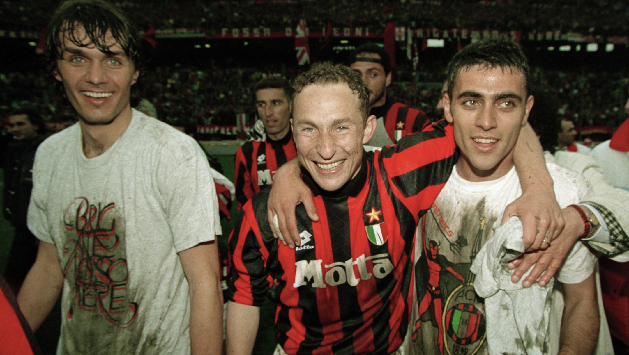 The AC Milan team celebrate after winning the Serie A League Championship, in Milan, circa May 1994. Identified are Paolo Maldini (left) and Jean-Pierre Papin (centre, red & black shirt). (Photo by Professional Sport/Popperfoto via Getty Images/Getty Images)