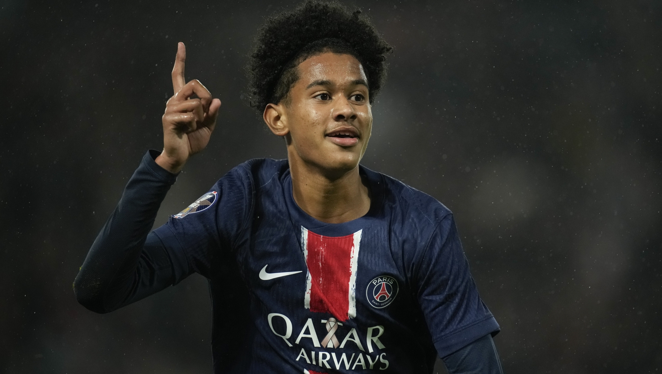 PSG's Senny Mayulu celebrates after scoring the opening goal during the French League One soccer match between Paris Saint-Germain and Strasbourg at the Parc des Princes in Paris, Saturday, Oct. 19, 2024. (AP Photo/Christophe Ena)