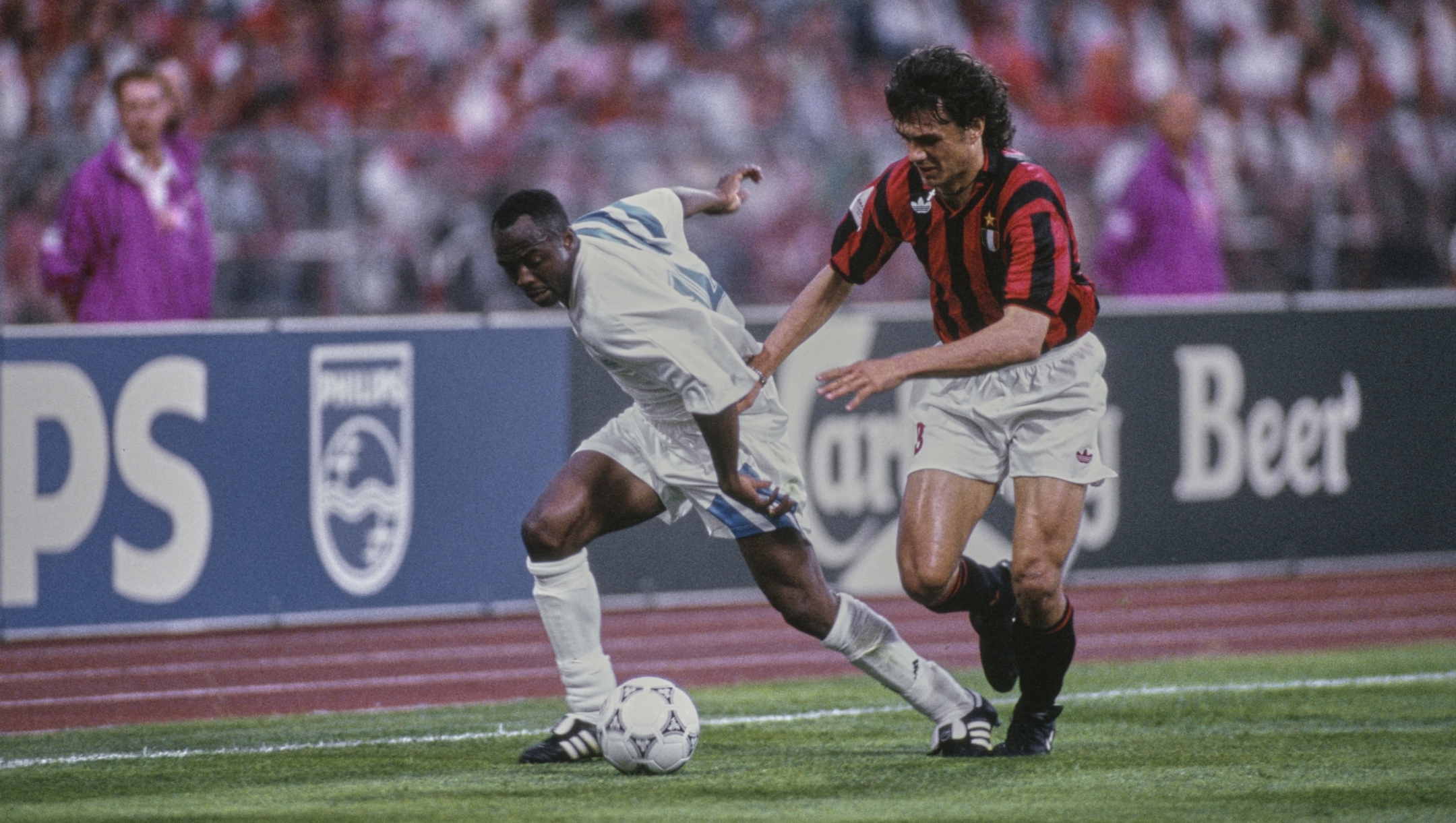 Ghanaian footballer Abedi Pele, of Marseille, under pressure from Italian footballer Paolo Maldini, of AC Milan, during the 1993 UEFA Champions League Final, between Marseille and AC Milan, at the Olympiastadion in Munich, Bavaria, Germany, 26th May 1993. Marseille won the match 1-0. (Photo by Beate Mueller/Bongarts/Getty Images)