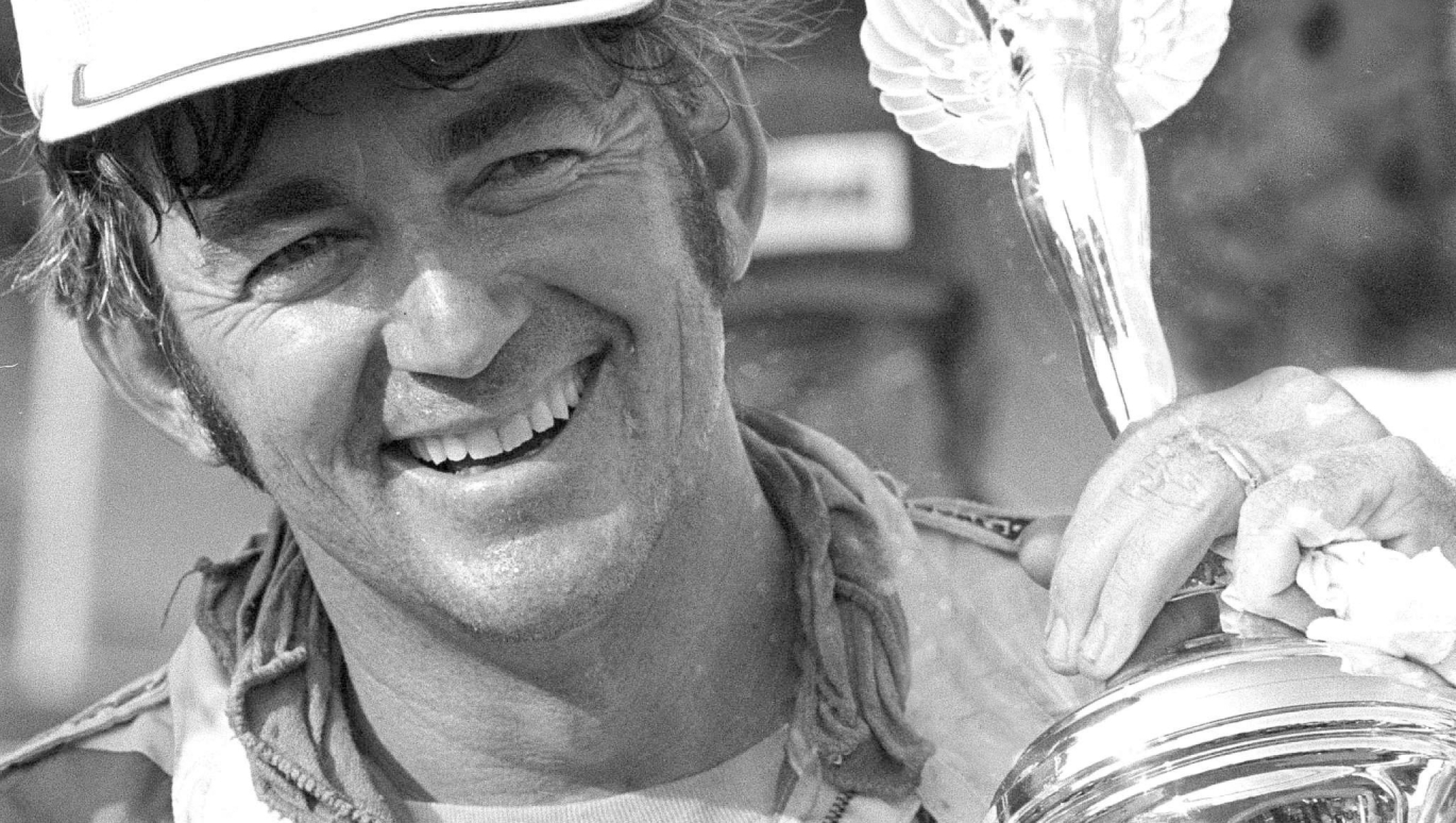 FILE - Bobby Allison shoulders his trophy in Victory Lane after winning the Southern 500 stock car race at Darlington, S.C., Sept. 1, 1975. (AP Photo, File)