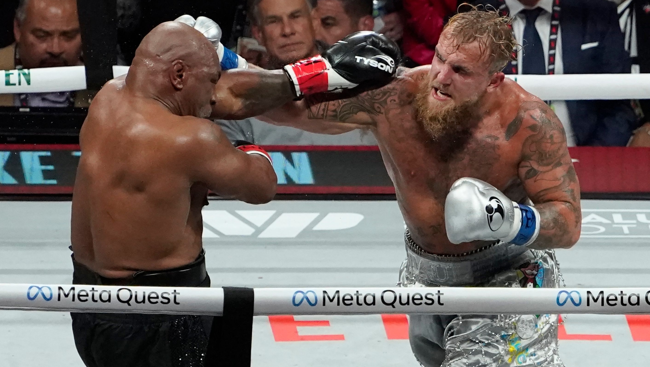 TOPSHOT - US retired pro-boxer Mike Tyson (L) and US YouTuber/boxer Jake Paul (R) fight during the heavyweight boxing bout at The Pavilion at AT&T Stadium in Arlington, Texas, November 15, 2024. (Photo by TIMOTHY A. CLARY / AFP)