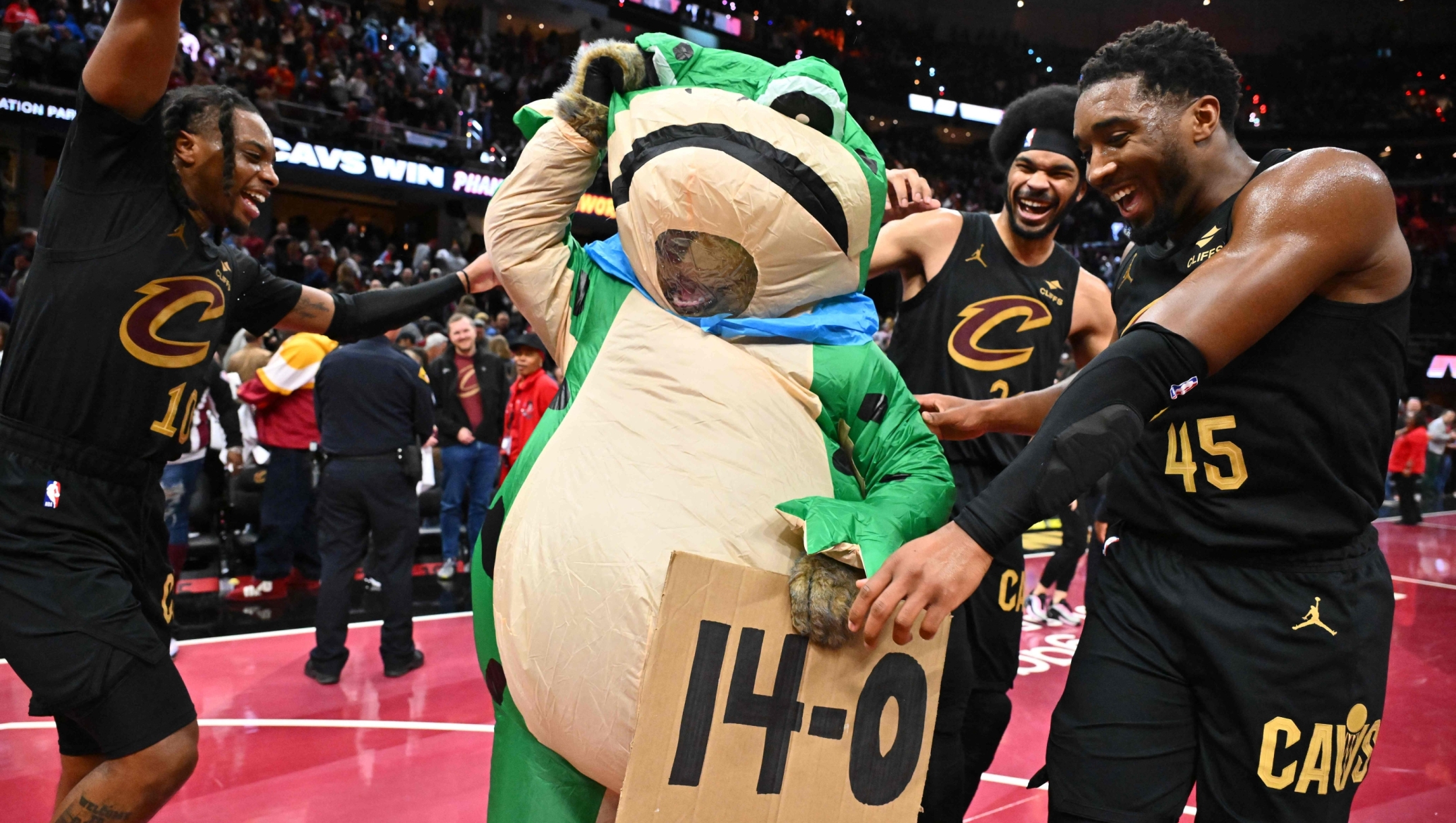 CLEVELAND, OHIO - NOVEMBER 15: Darius Garland #10 Jarrett Allen #31 and Donovan Mitchell #45 of the Cleveland Cavaliers celebrate with a frog mascot after defeating the Chicago Bulls during of the Emirates NBA Cup game at Rocket Mortgage Fieldhouse on November 15, 2024 in Cleveland, Ohio. The Cavaliers defeated the Bulls 144-126. NOTE TO USER: User expressly acknowledges and agrees that, by downloading and or using this photograph, User is consenting to the terms and conditions of the Getty Images License Agreement.   Jason Miller/Getty Images/AFP (Photo by Jason Miller / GETTY IMAGES NORTH AMERICA / Getty Images via AFP)