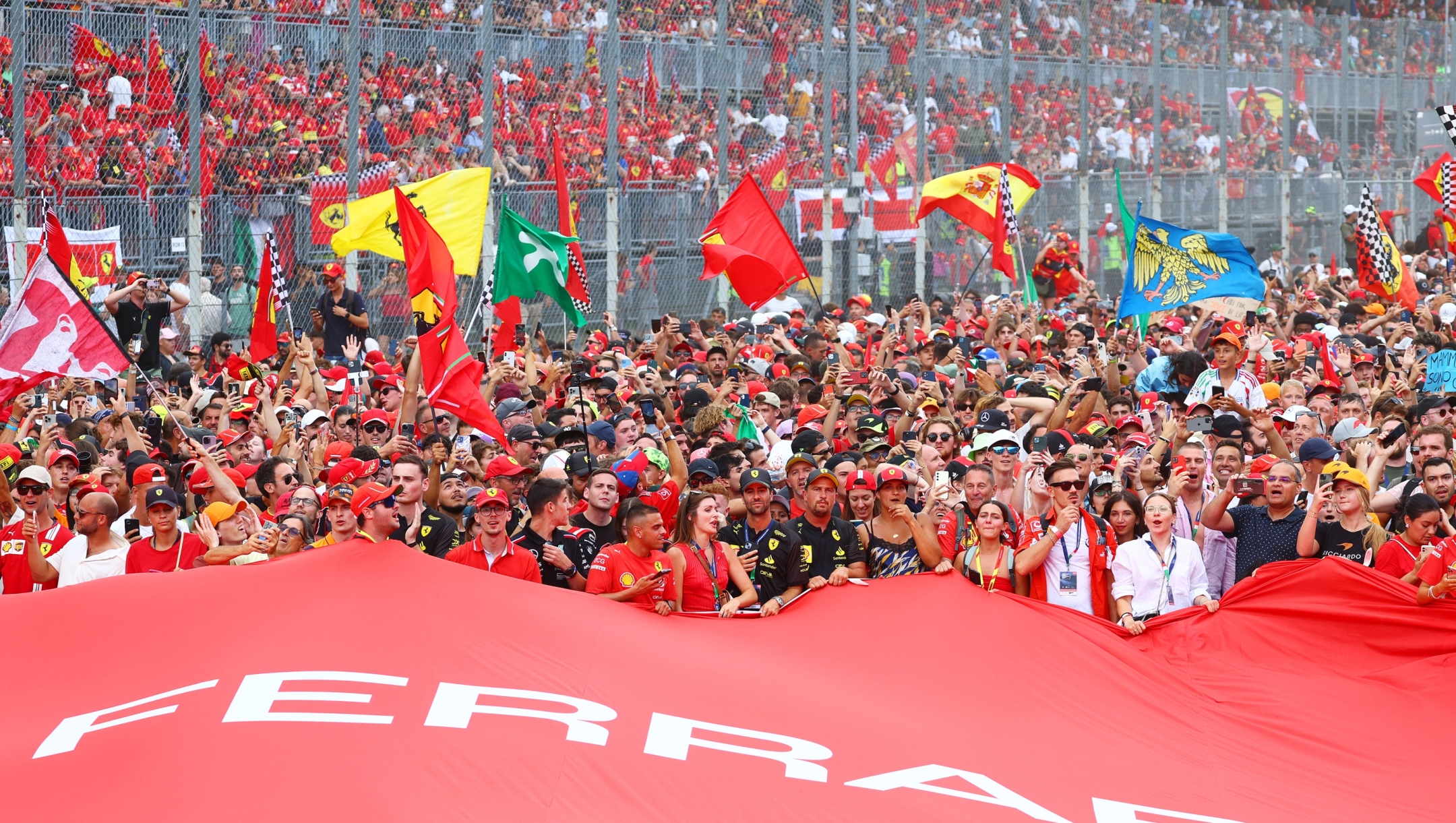 MONZA, ITALY - SEPTEMBER 01: Fans fill the track to watch the podium ceremony during the F1 Grand Prix of Italy at Autodromo Nazionale Monza on September 01, 2024 in Monza, Italy. (Photo by Clive Rose/Getty Images) *** BESTPIX ***