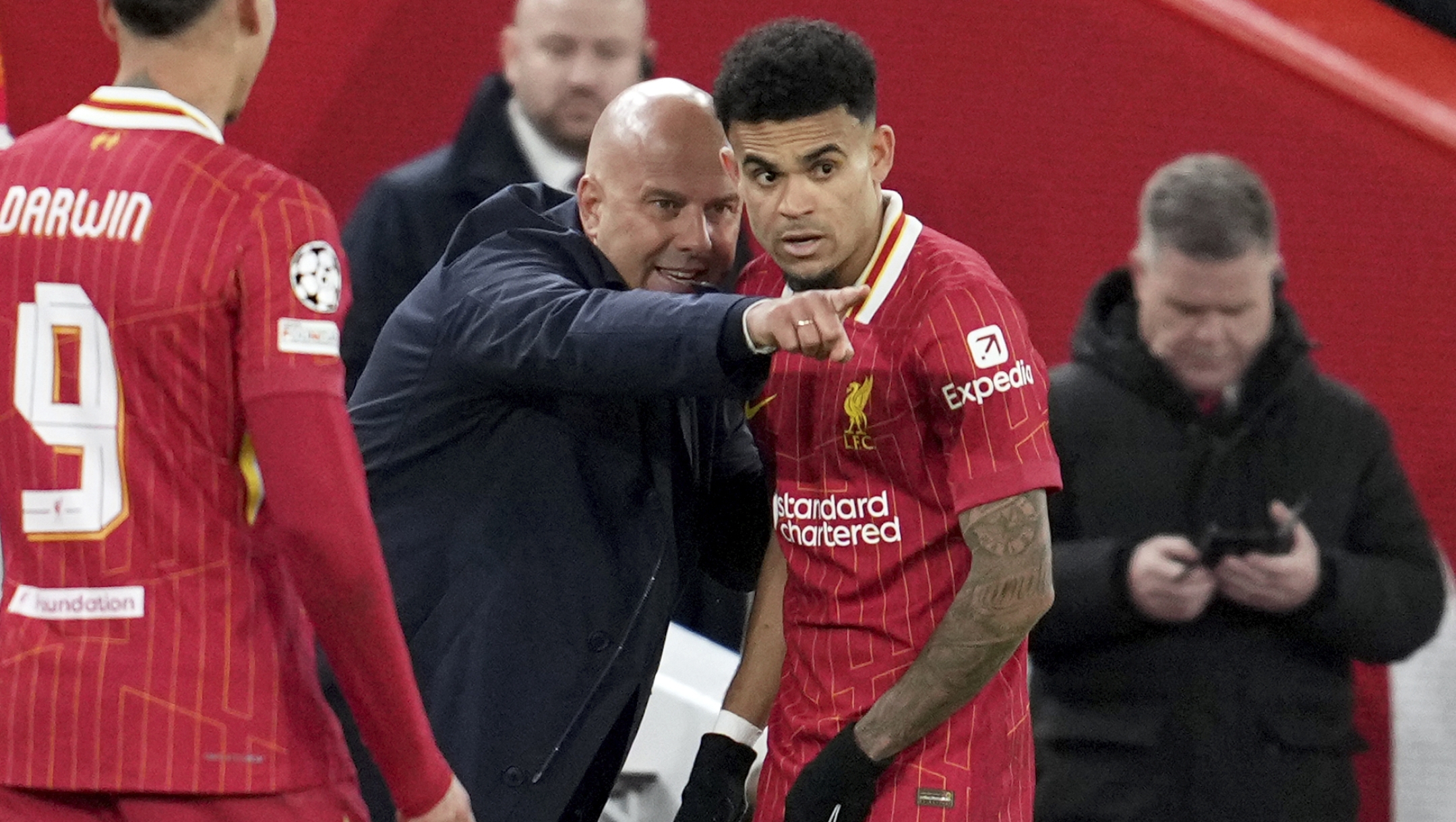 Liverpool's manager Arne Slot speaks to Liverpool's Luis Diaz during the Champions League opening phase soccer match between Liverpool and Real Madrid at Anfield Stadium, Liverpool, England, Wednesday, Nov. 27, 2024. (AP Photo/Jon Super)