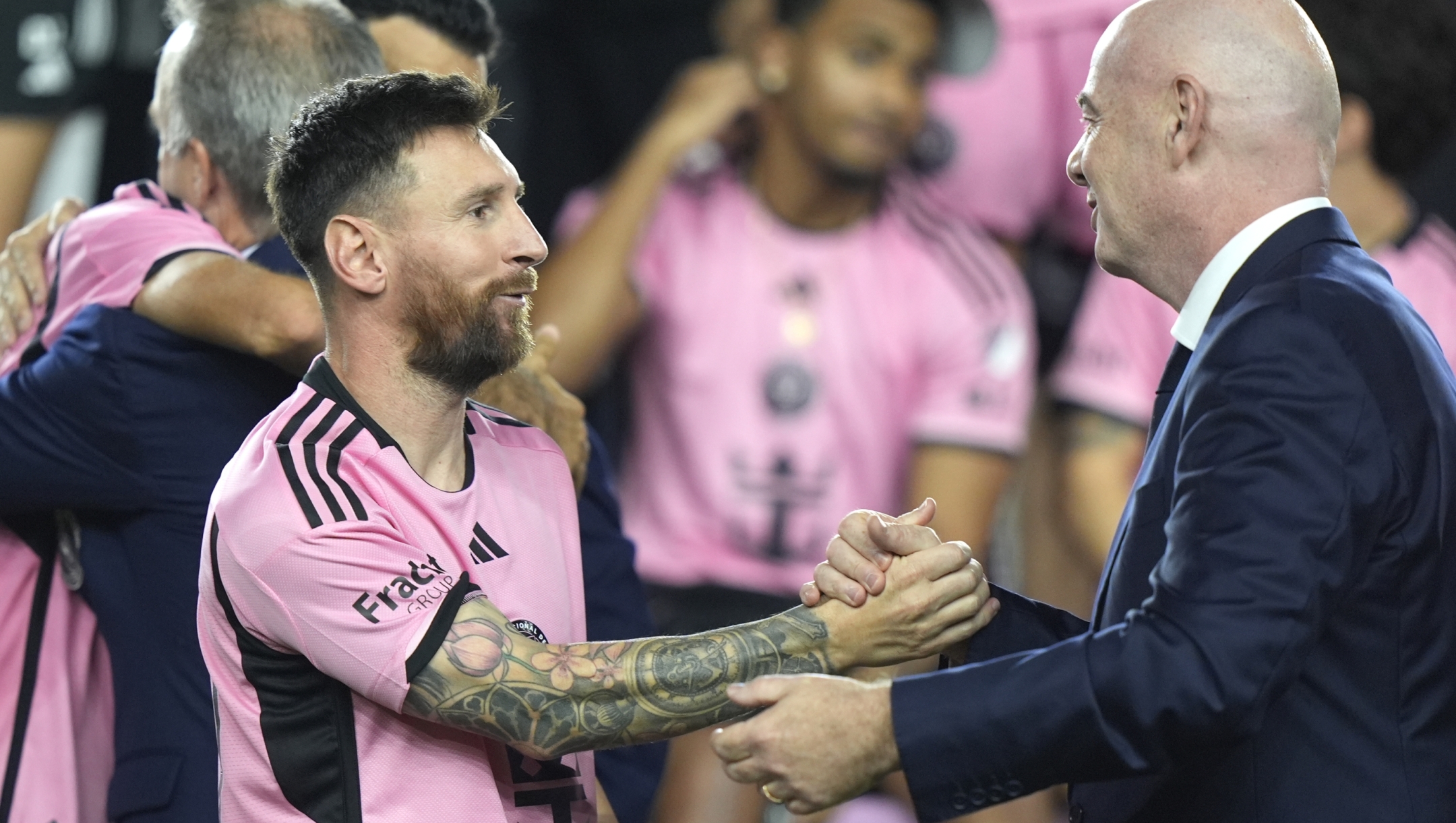 Inter Miami forward Lionel Messi, left, shakes hands with FIFA President Gianni Infantino, right, during a ceremony for the team winning the Supporters' Shield after an MLS soccer match against the New England Revolution, Saturday, Oct. 19, 2024, in Fort Lauderdale, Fla. (AP Photo/Lynne Sladky)