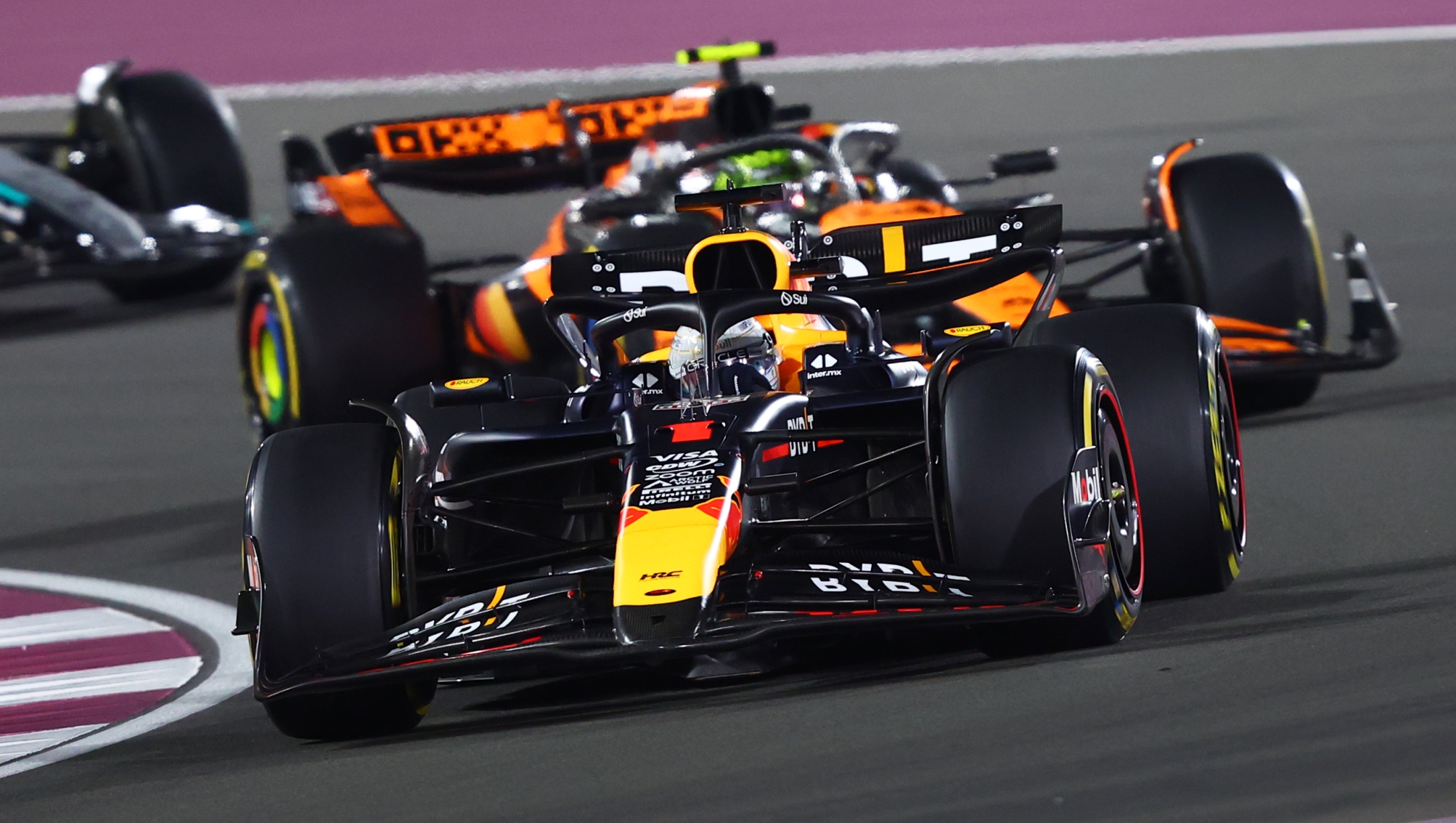 LUSAIL CITY, QATAR - DECEMBER 01: Max Verstappen of the Netherlands driving the (1) Oracle Red Bull Racing RB20 leads Lando Norris of Great Britain driving the (4) McLaren MCL38 Mercedes on track during the F1 Grand Prix of Qatar at Lusail International Circuit on December 01, 2024 in Lusail City, Qatar. (Photo by Joe Portlock/Getty Images)