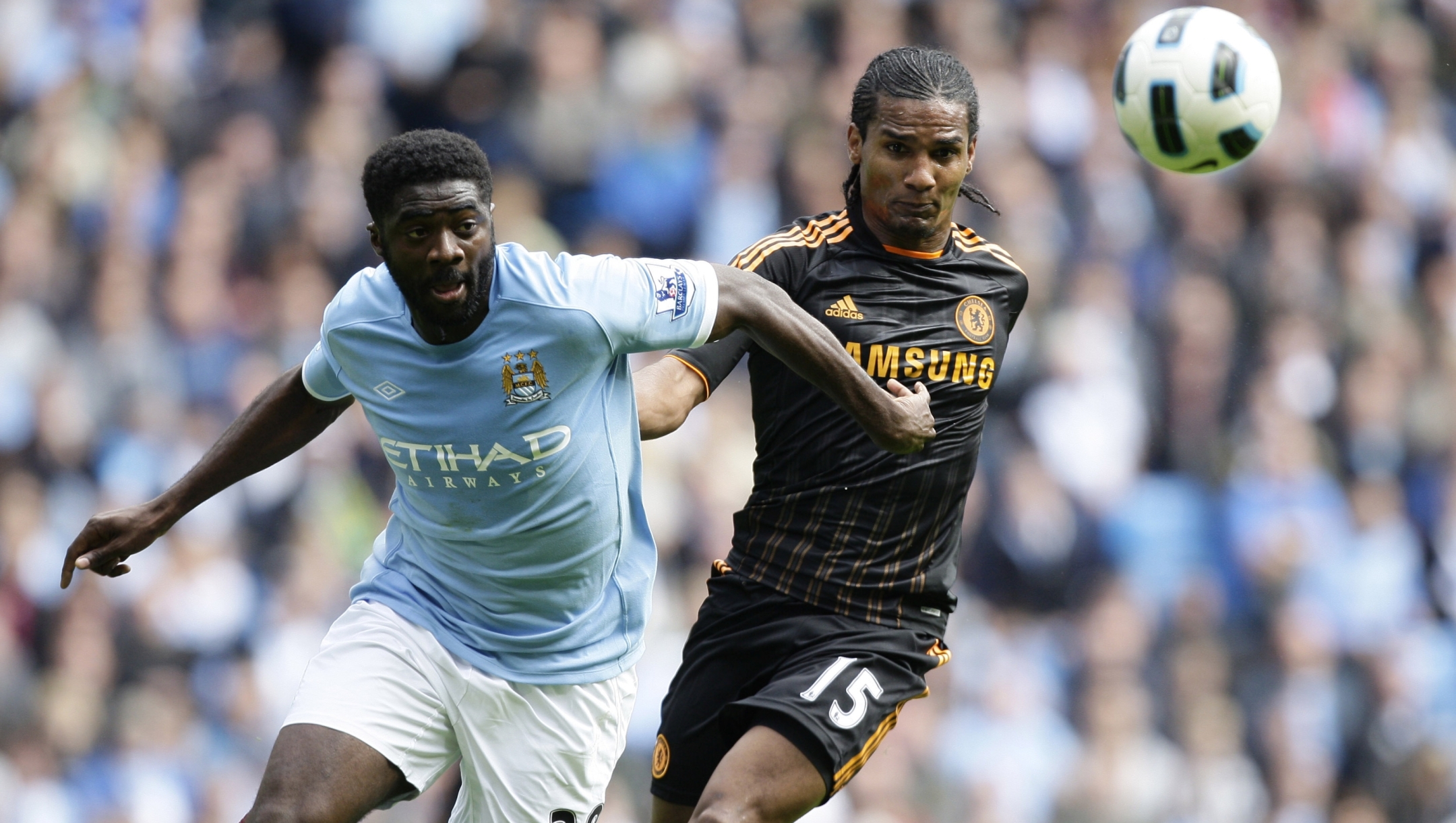 Chelsea's Florent Malouda, right, fights for the ball against Manchester City's Kolo Toure during their English Premier League soccer match at The City of Manchester Stadium, Manchester, England, Saturday Sept. 25, 2010. (AP Photo/Jon Super) ** NO INTERNET/MOBILE USAGE WITHOUT FOOTBALL ASSOCIATION PREMIER LEAGUE(FAPL)LICENCE. EMAIL info@football-dataco.com FOR DETAILS. **