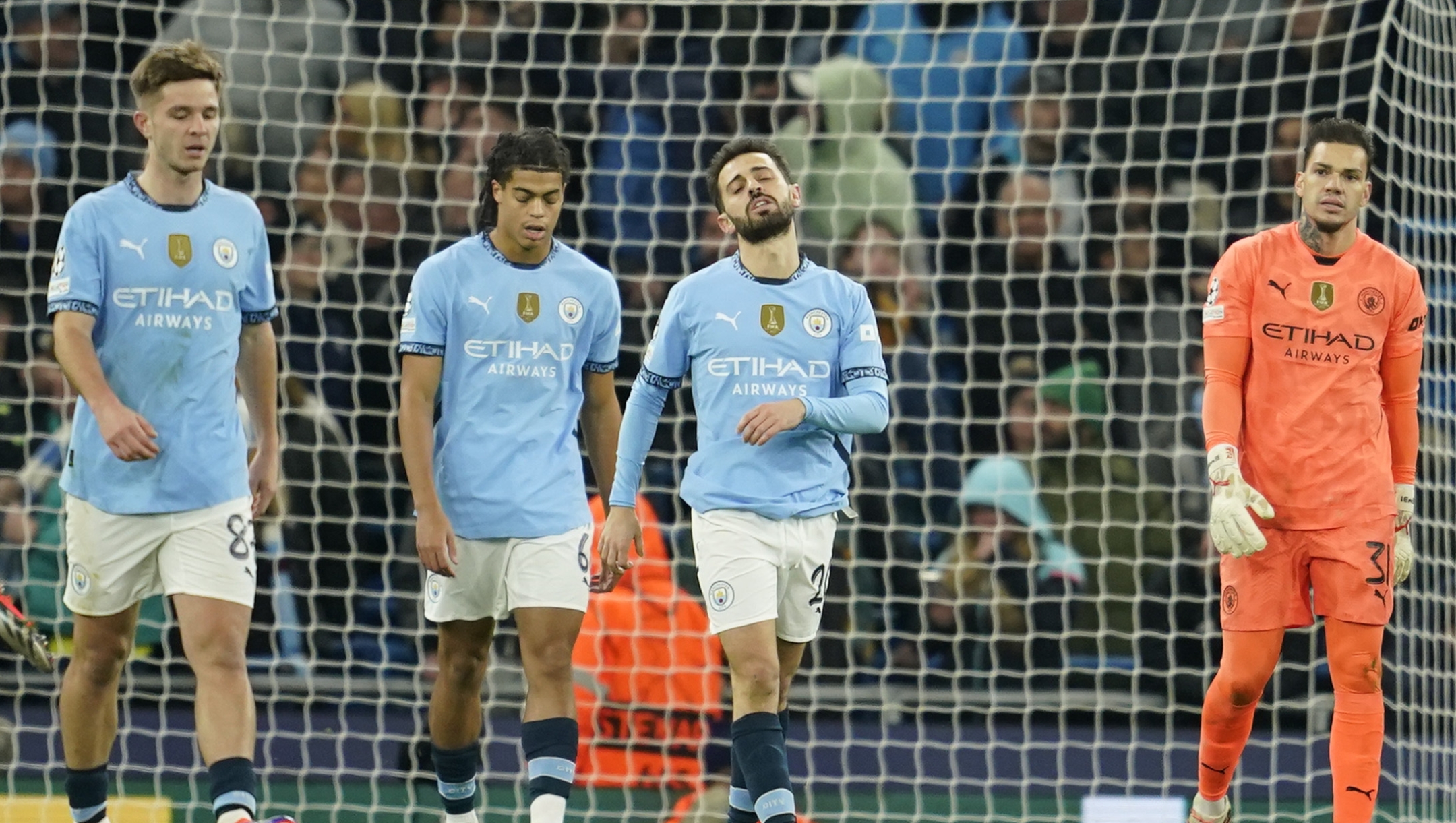 Manchester City's Bernardo Silva, second right, reacts after Feyenoord scored their third goal during the Champions League opening phase soccer match between Manchester City and Feyenoord at the Etihad Stadium in Manchester, England, Tuesday, Nov. 26, 2024. (AP Photo/Dave Thompson)