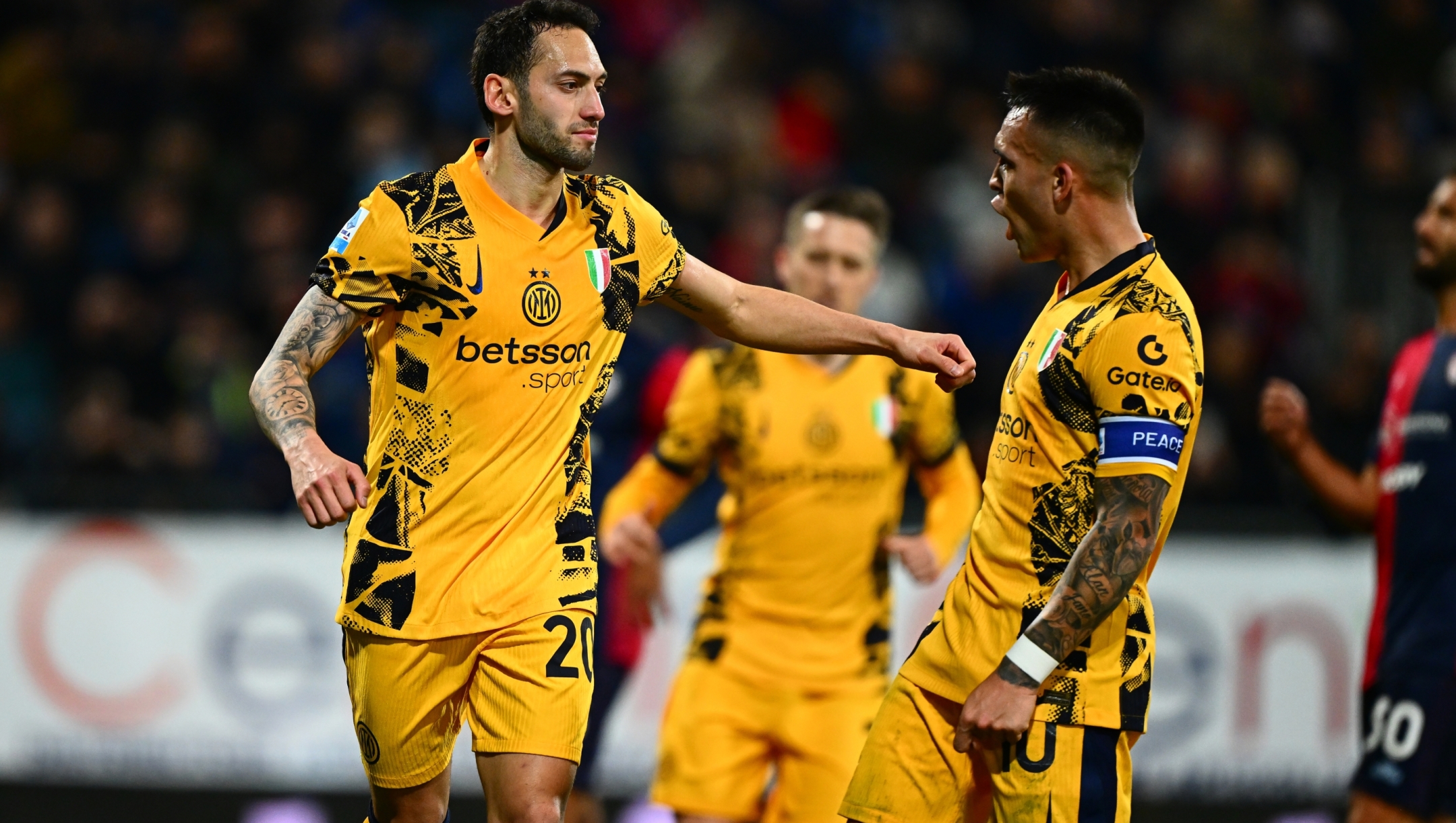 CAGLIARI, ITALY - DECEMBER 28:  Hakan Calhanoglu of FC Internazionale celebrates with Lautaro after scoring the goal during the Serie A match between Cagliari and FC Internazionale at Sardegna Arena on December 28, 2024 in Cagliari, Italy. (Photo by Mattia Pistoia - Inter/Inter via Getty Images)