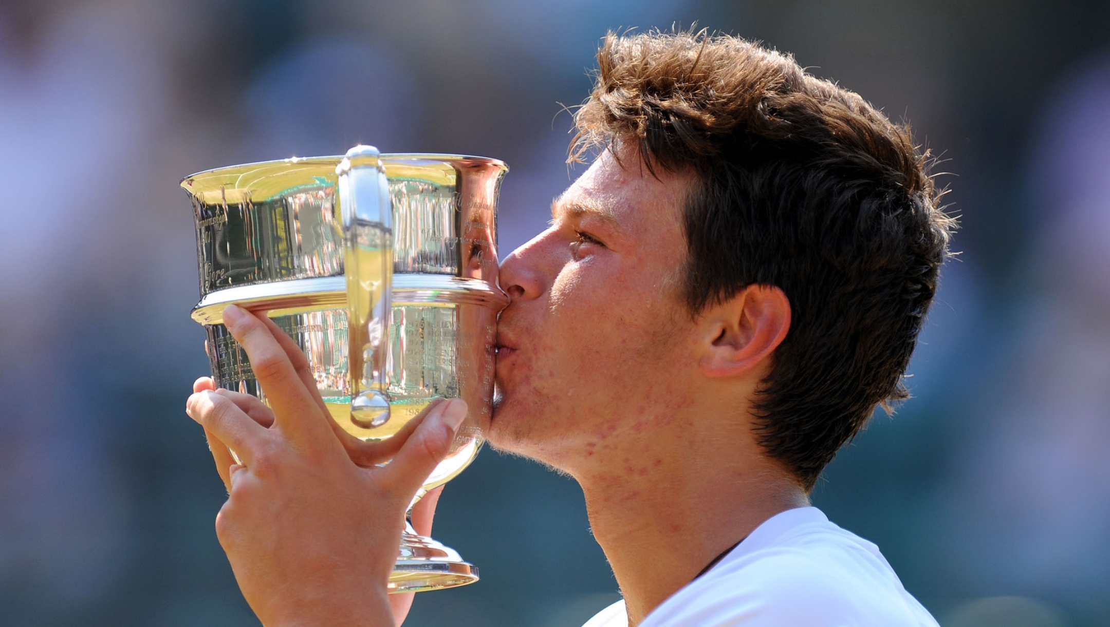 Italy's Gianluigi Quinzi  kisses the trophy after defeating Korea's Hyeon Chung in the Boys' Singles Final during day thirteen of the Wimbledon Championships at The All England Lawn Tennis and Croquet Club, Wimbledon, London, Sunday July 7, 2013. (AP Photo/Dominic Lipinski, PA) UNITED KINGDOM OUT NO SALES NO ARCHIVE