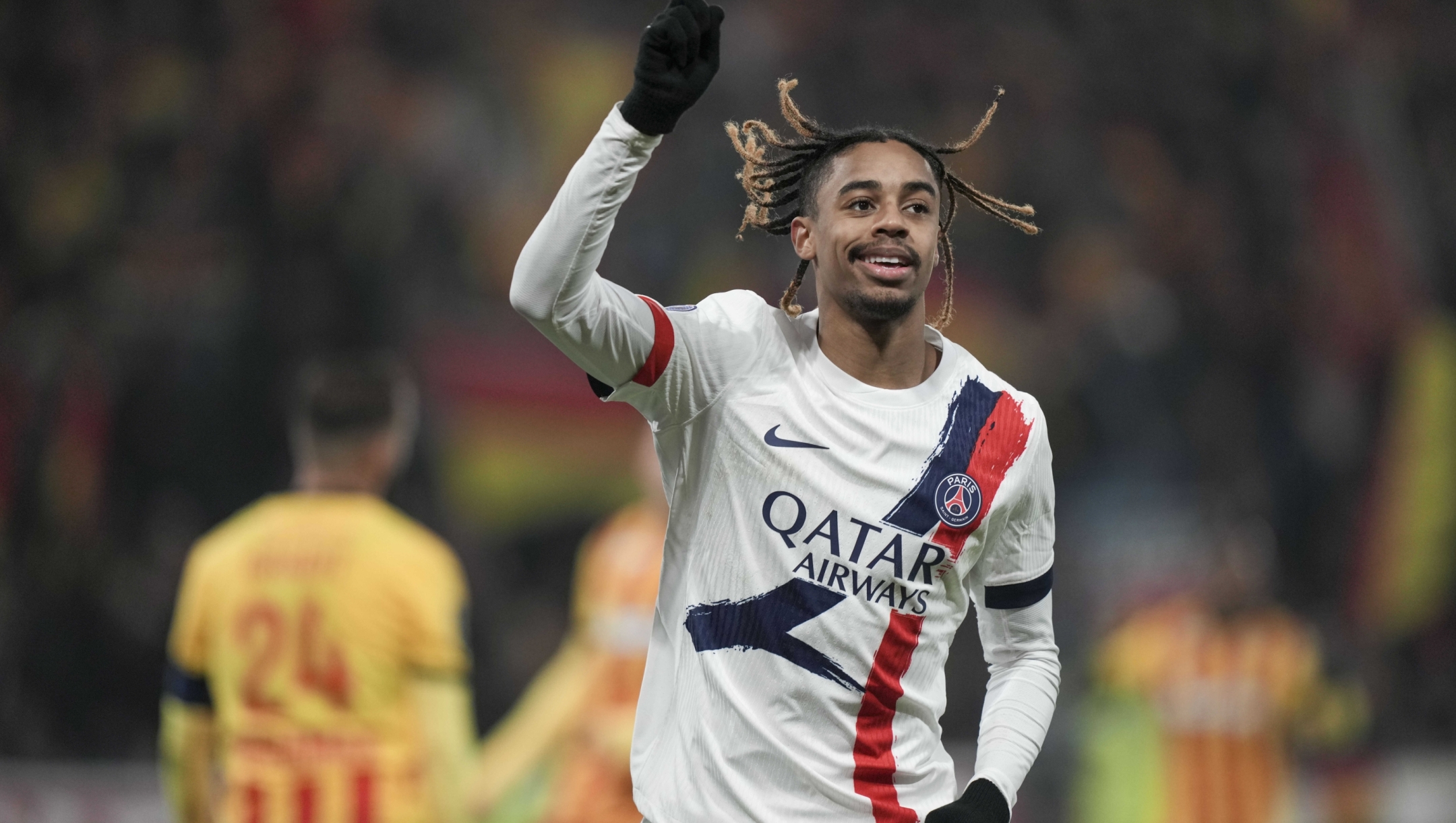 PSG's Bradley Barcola celebrates after he scored his side's second goal during the French League One soccer match between Lens and Paris Saint-Germain, at the Bollaert-Delelis stadium in Lens, France, Saturday, Jan. 18, 2025. (AP Photo/Thibault Camus)