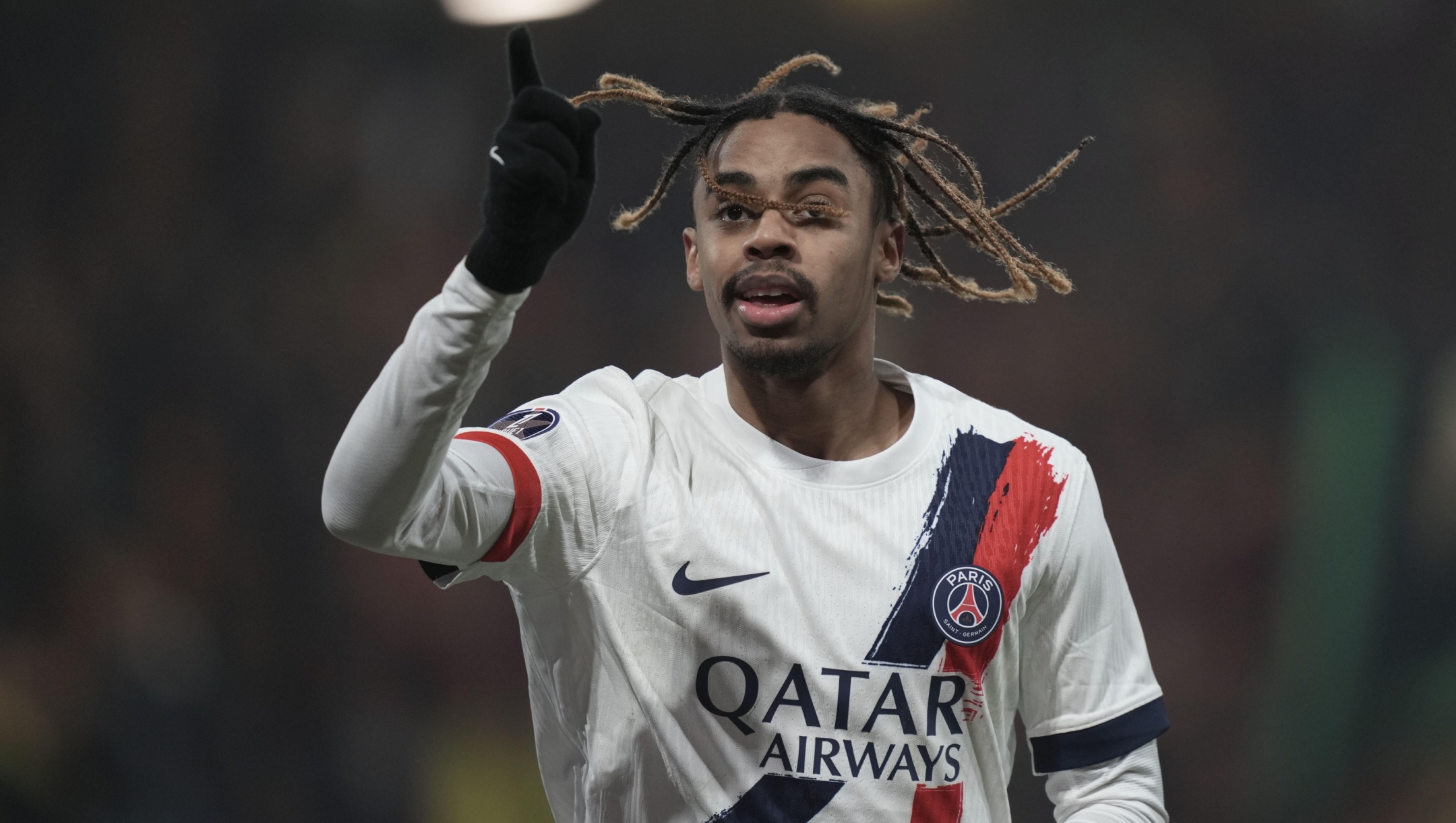 PSG's Bradley Barcola celebrates after he scored his side's second goal during the French League One soccer match between Lens and Paris Saint-Germain, at the Bollaert-Delelis stadium in Lens, France, Saturday, Jan. 18, 2025. (AP Photo/Thibault Camus)