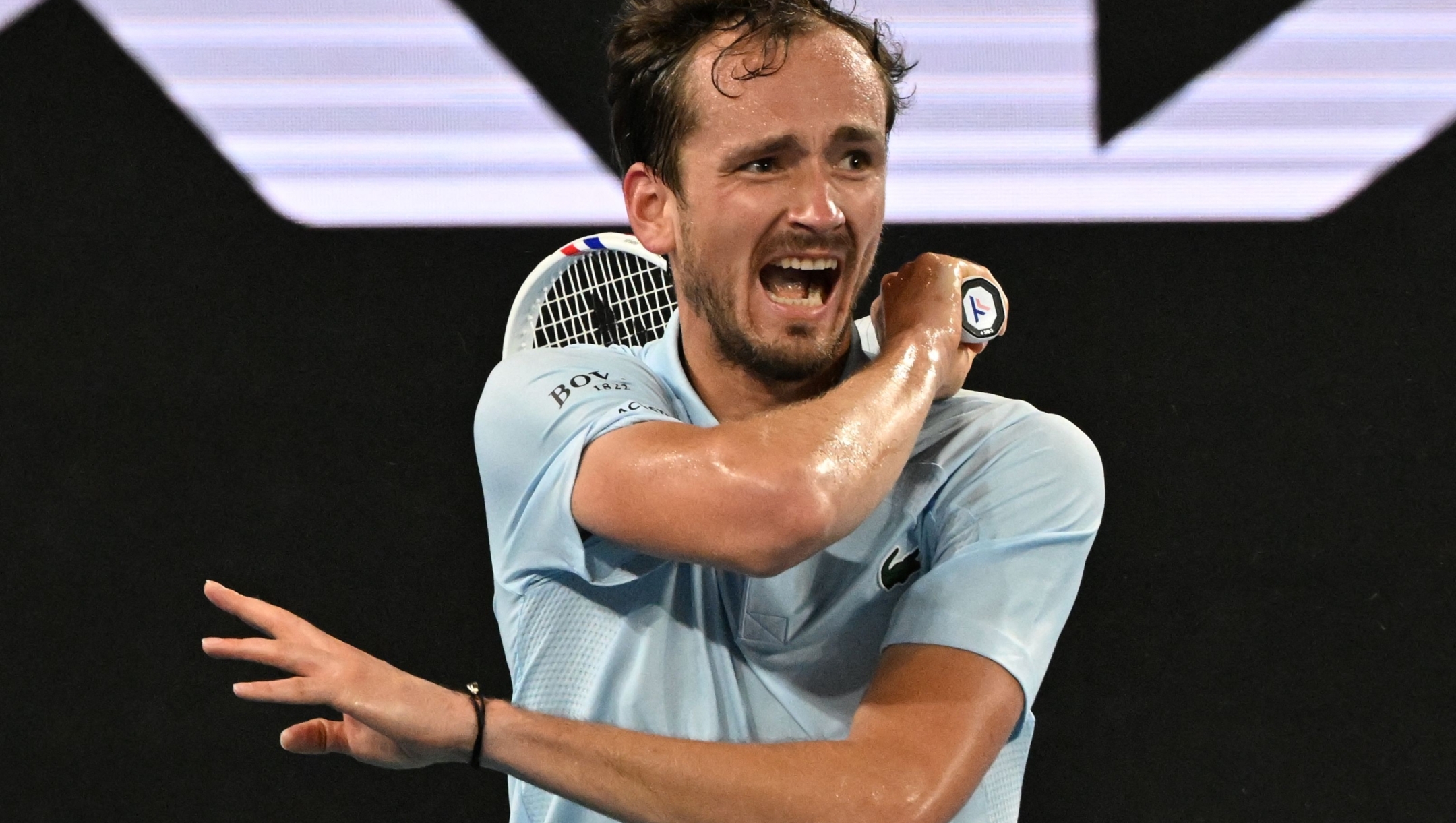 TOPSHOT - Russia's Daniil Medvedev hits a return against USA's Learner Tien during their men's singles match on day five of the Australian Open tennis tournament in Melbourne on January 16, 2025. (Photo by Paul Crock / AFP) / -- IMAGE RESTRICTED TO EDITORIAL USE - STRICTLY NO COMMERCIAL USE --