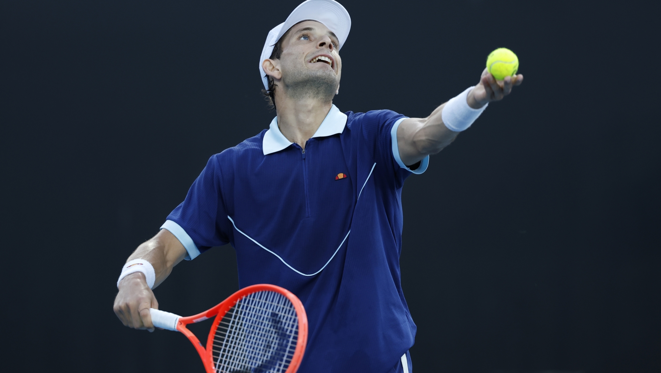 MELBOURNE, AUSTRALIA - JANUARY 13: Francesco Passaro of Italy serves against Grigor Dimitrov of Bulgaria in the Men's Singles First Round match during day two of the 2025 Australian Open at Melbourne Park on January 13, 2025 in Melbourne, Australia. (Photo by Darrian Traynor/Getty Images)