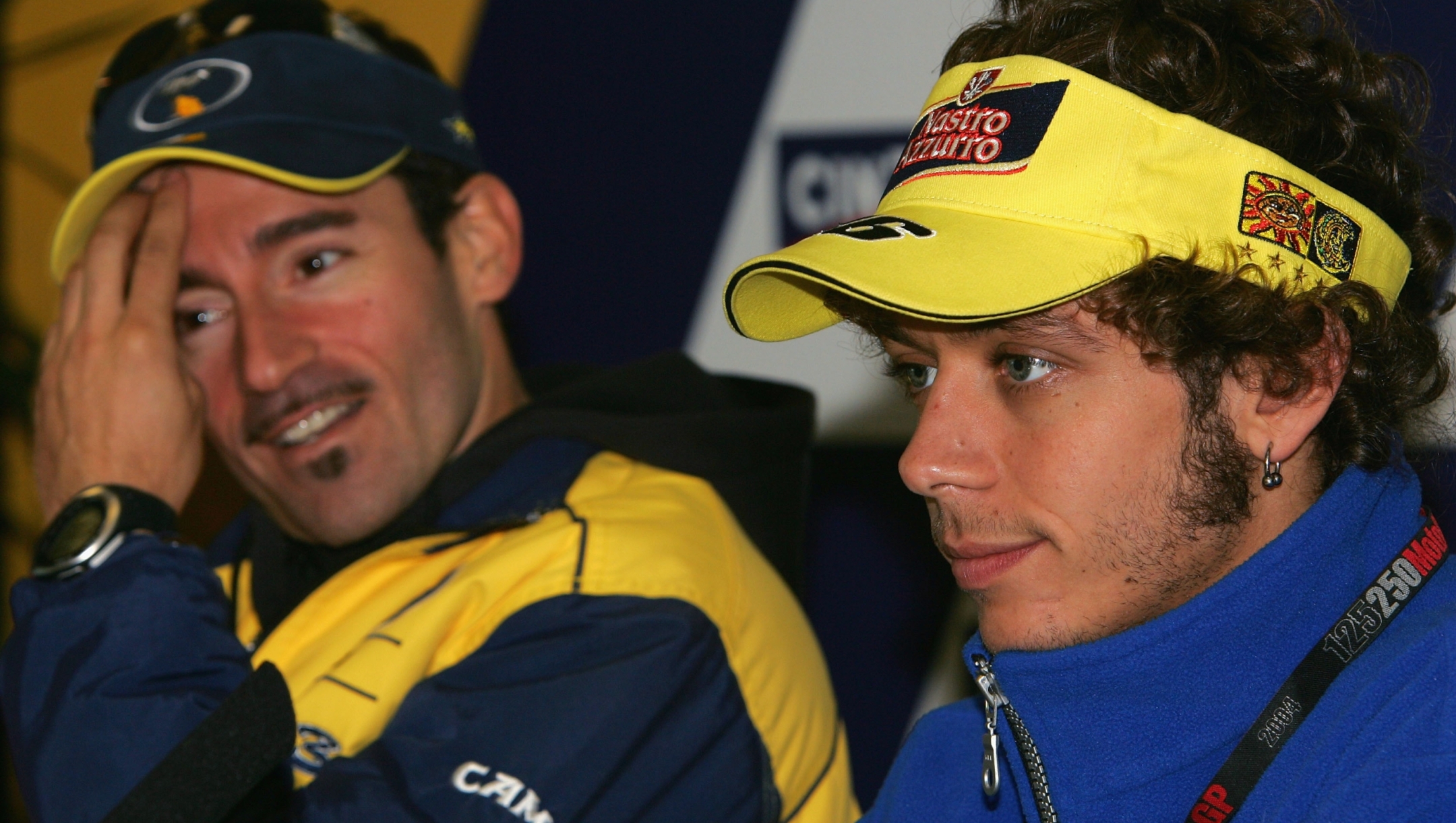 PHILLIP ISLAND,AUSTRALIA - OCTOBER 14: Valentino Rossi of Italy and the Gauloises Fortuna Yamaha Team speaks to the media as Max Biaggi Biaggi listens on at the MotoGp press conference as he prepares for the Australian MotoGp which is round 15 of the MotoGp Championship Series on October 14, 2004 at Phillip Island, Australia.(Photo by Robert Cianflone/Getty Images) *** Local Caption *** Valentino Rossi;Max Biaggi