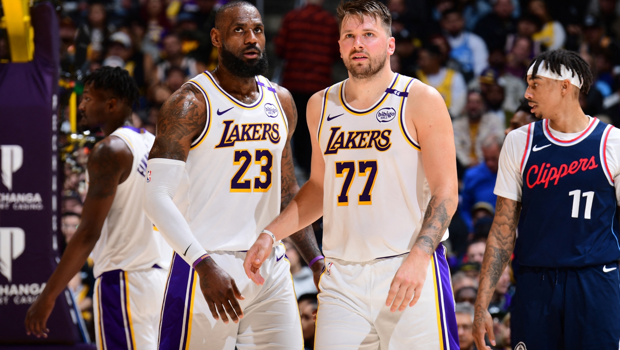 LeBron James #23 and Luka Doncic #77 of the Los Angeles Lakers looks on during the game against the LA Clippers on March 2, 2025 at Crypto.Com Arena in Los Angeles, California. NOTE TO USER: User expressly acknowledges and agrees that, by downloading and/or using this Photograph, user is consenting to the terms and conditions of the Getty Images License Agreement. Mandatory Copyright Notice: Copyright 2025 NBAE Adam Pantozzi/NBAE via Getty Images/AFP (Photo by Adam Pantozzi / NBAE / Getty Images / Getty Images via AFP)