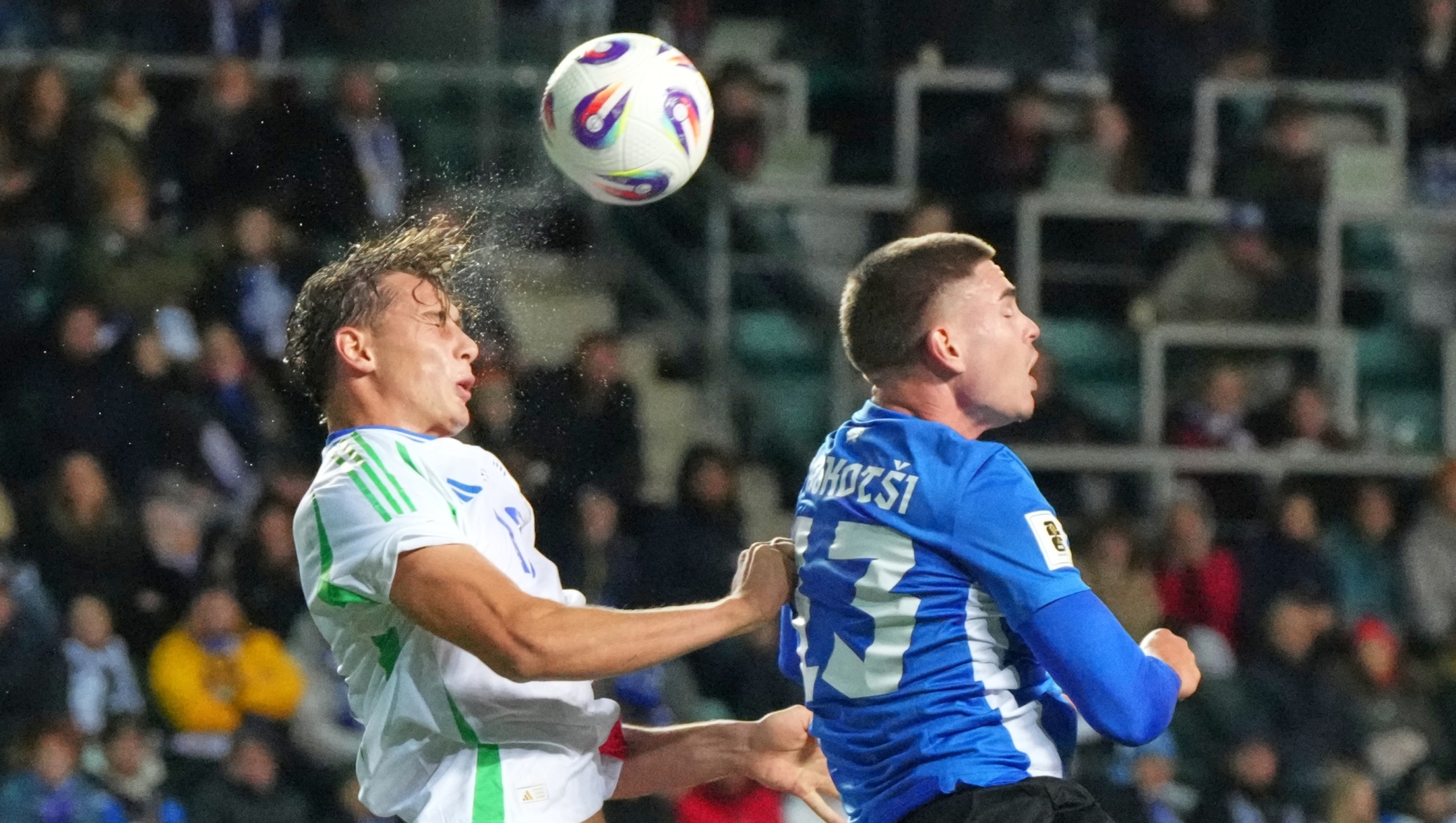 Italy's Francesco Pio Esposito, left, and Estonia's Maksim Paskotsi battle for the ball during a World Cup 2026 group I qualifying soccer match between Estonia and Italy in Tallinn, Estonia, Saturday, Oct. 11, 2025. (AP Photo/Sergei Grits)