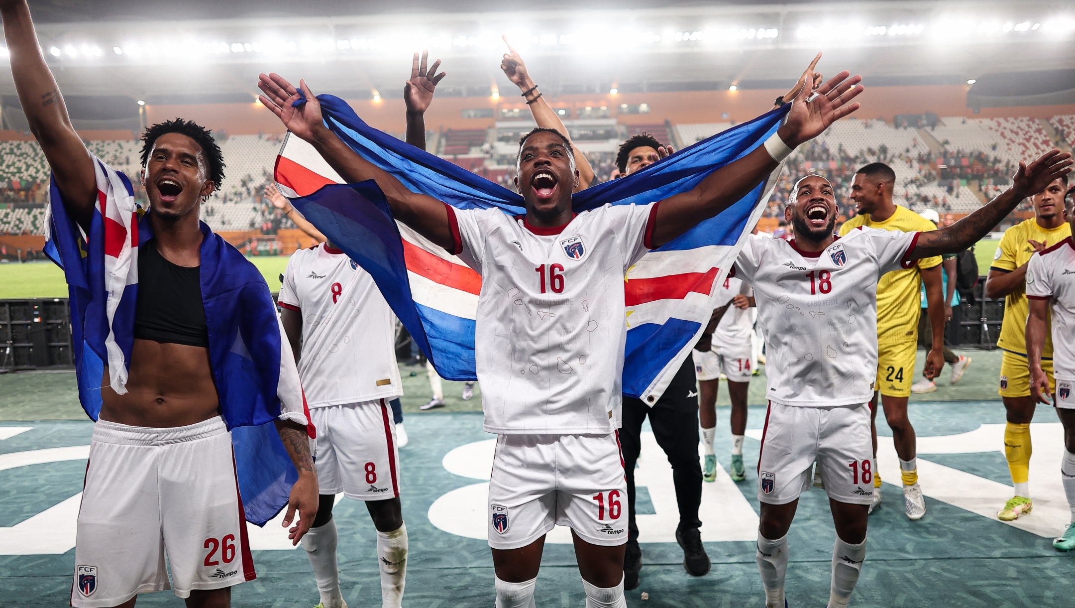 Cape Verde's defender #16 Dylan Tavares (C) and Cape Verde's players celebrate after the victory at the end of the Africa Cup of Nations (CAN) 2024 round of 16 football match between Cape Verde and Mauritania at the Felix Houphouet-Boigny Stadium in Abidjan on January 29, 2024. (Photo by FRANCK FIFE / AFP)