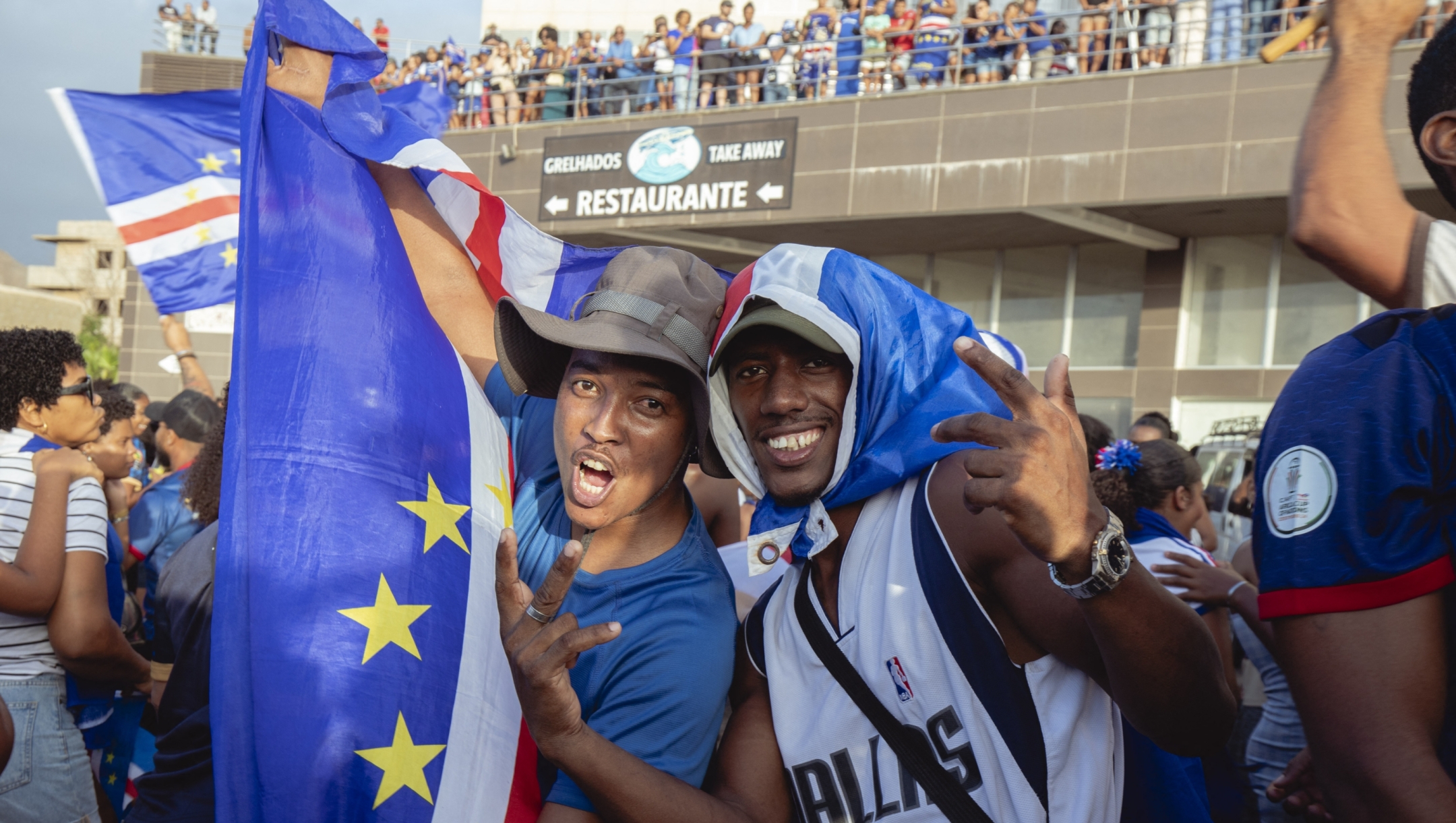 Supporters celebrate Cape Verde&#146;s victory against Eswatini during the FIFA World Cup 2026 Africa qualifiers group D match at a fan zone in Sao Vicente, Cape Verde, on October 13, 2025. A carnival-like atmosphere erupted in the streets of Cape Verde on Monday after the tiny archipelago nation qualified for the first time ever for the World Cup. Located off the coast of Senegal, it is the country with the smallest population to represent Africa in the global showpiece, with just 550,000 inhabitants. (Photo by QUEILA FERNANDES / AFP)