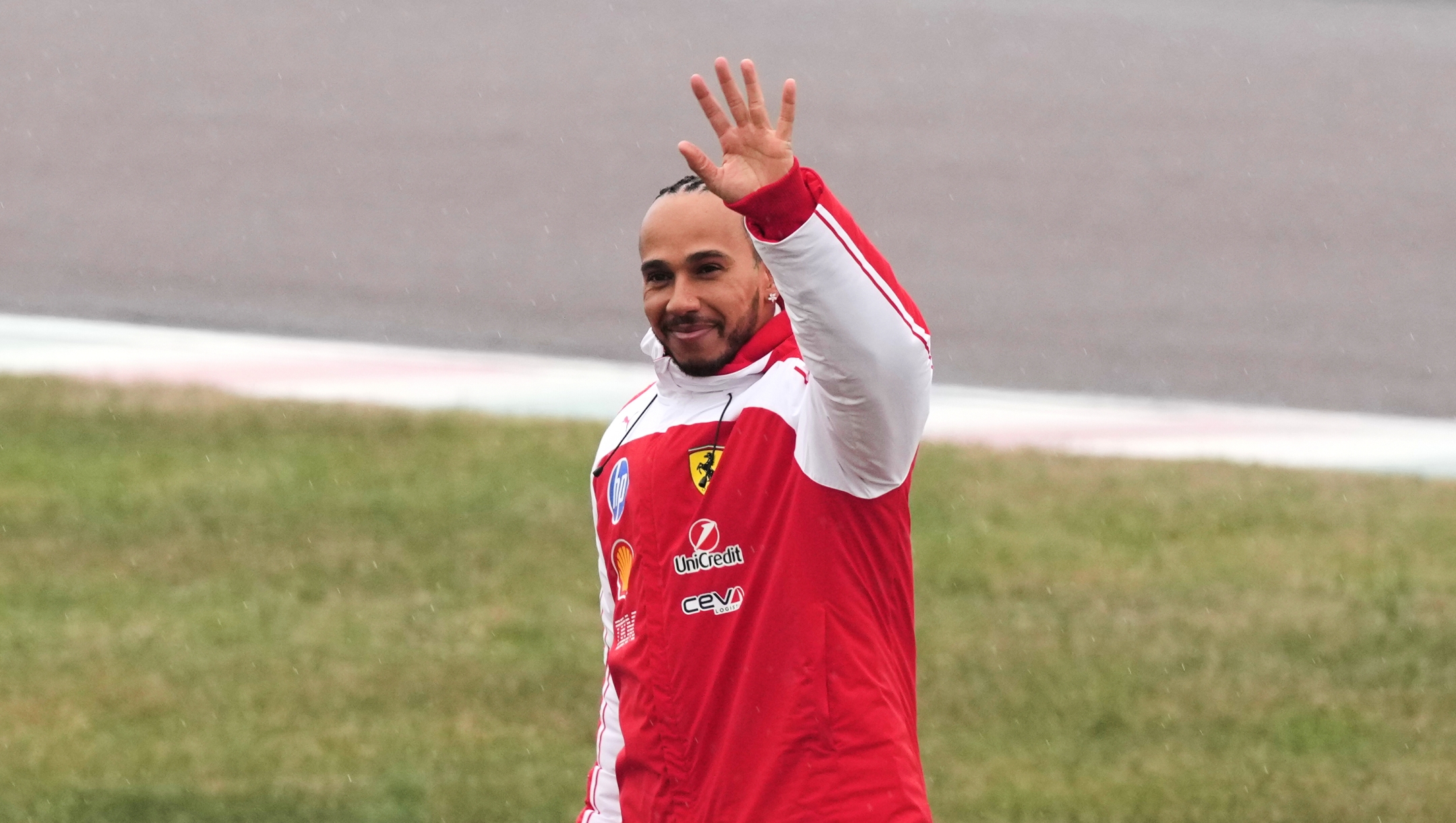 Ferrari driver Lewis Hamilton waves to fans after driving a new Ferrari Formula One SF-26 at the Ferrari private test track, in Fiorano Modenese, Italy, Friday, Jan. 23, 2026. (AP Photo/Antonio Calanni)      Associate Press/ LaPresse Only Italy and Spain