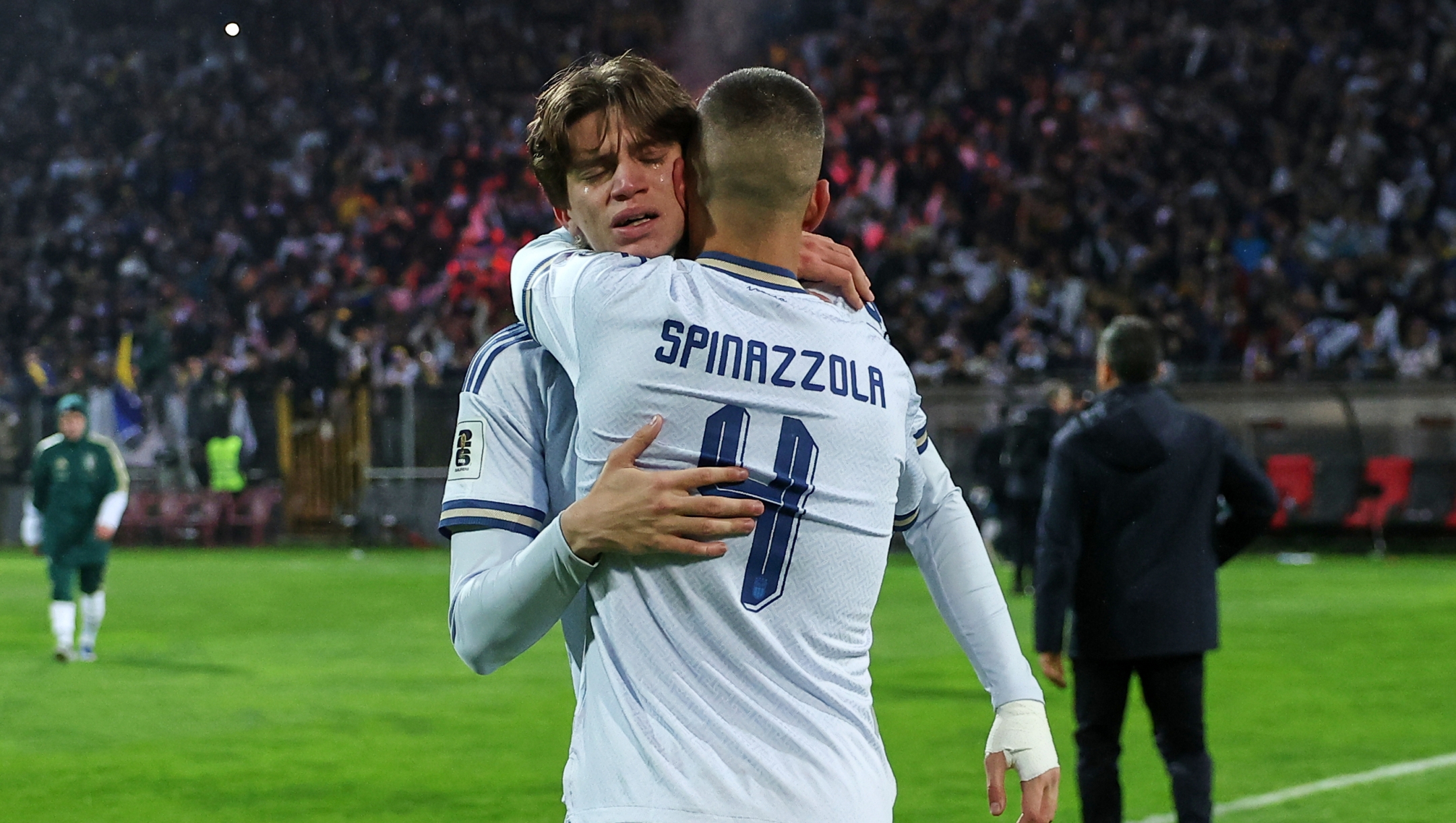 Italy's Marco Palestra and Leonardo Spinazzola console each other after losing a penalty shootout during the World Cup qualifying playoff final soccer match between Bosnia and Italy in Zenica, Bosnia, Tuesday, March 31, 2026. (AP Photo/Armin Durgut)