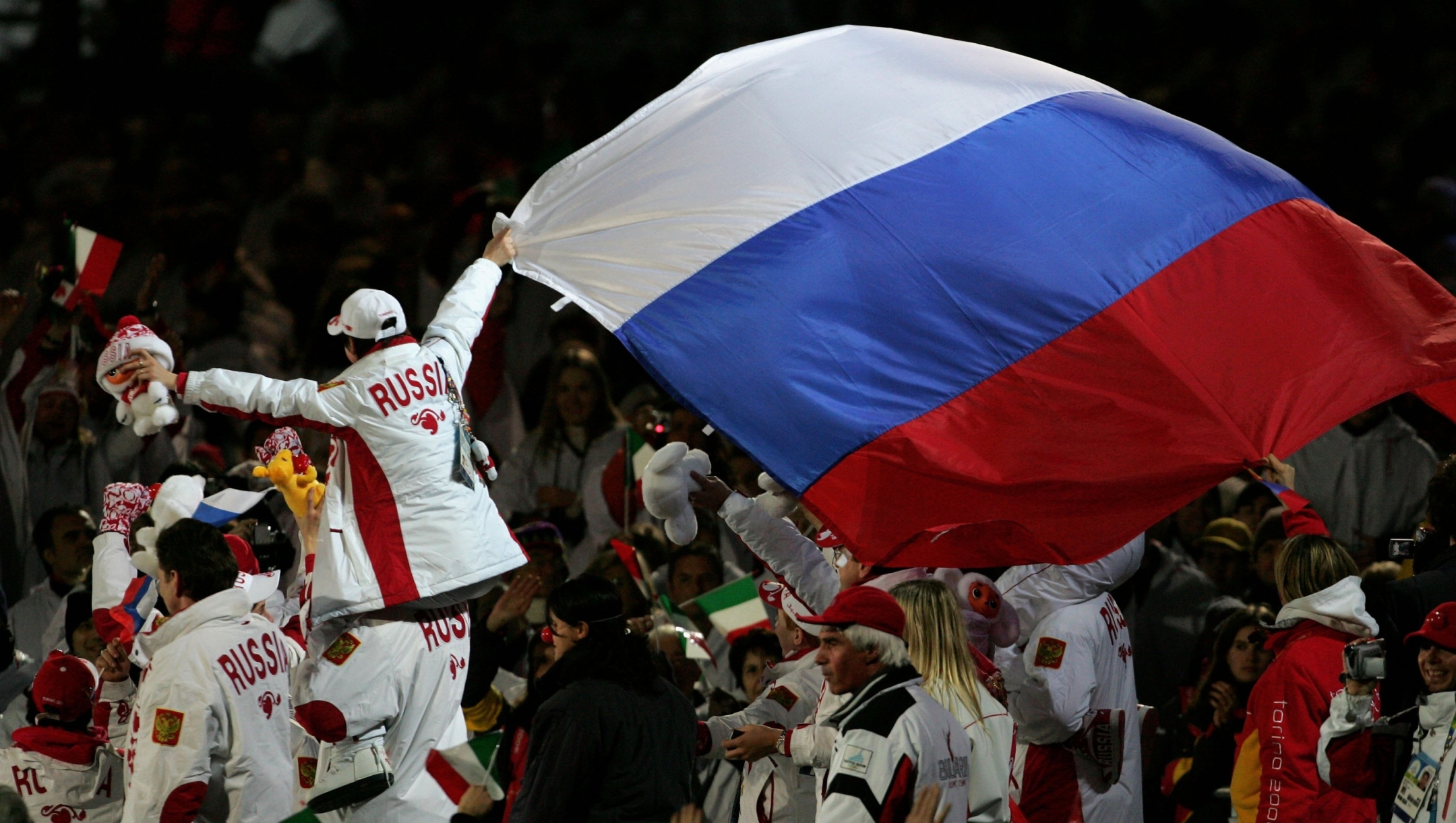   Russian athlete's hold a flag during the Closing Ceremony of the Turin 2006 Winter Olympic Games on February 26, 2006 at the Olympic Stadium in Turin, Italy.  (Photo by Clive Rose/Getty Images)