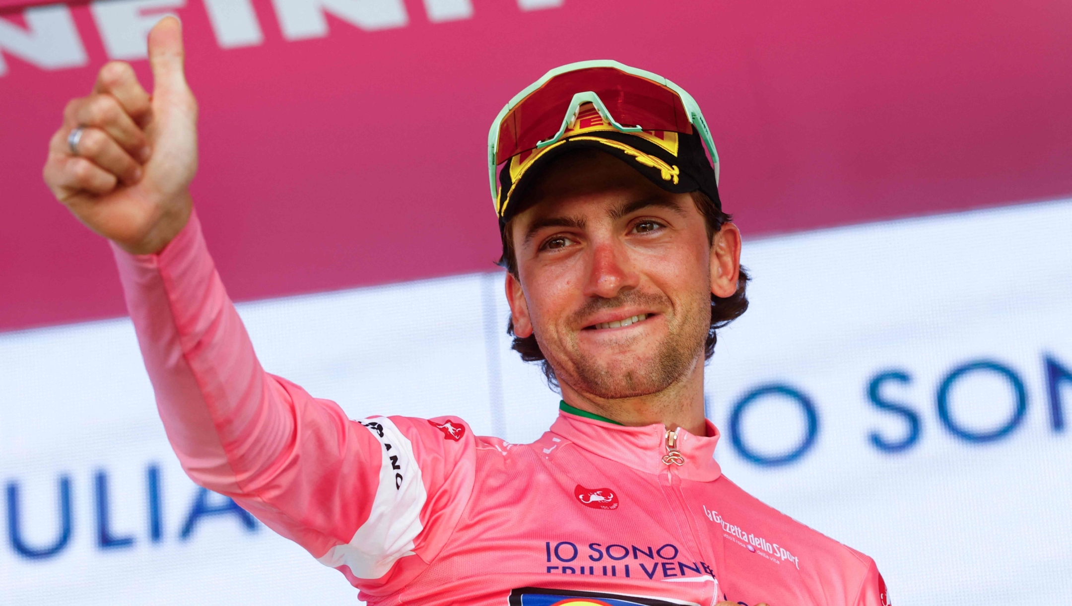 Lidl - Trek Italian rider Giulio Ciccone wearing the overall leader's pink jersey (Maglia Rosa) reacts on the podium after the after winning the 4th stage of the Giro d'Italia 2026 - Tour of Italy cycling race between Catanzaro and Cosenza, Italy, on May 12, 2026. (Photo by Luca Bettini / AFP)