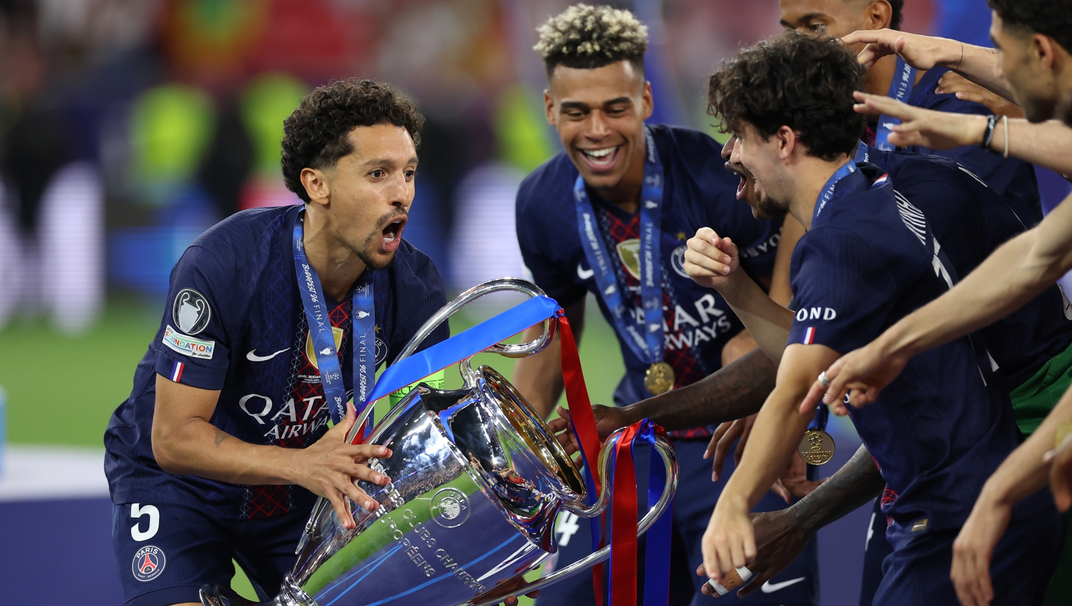 PSG players celebrate with a trophy after the Champions League final soccer match between Paris Saint-Germain and Arsenal in Budapest, Hungary, Saturday, May 30, 2026. AP Photo/Armin Durgut)