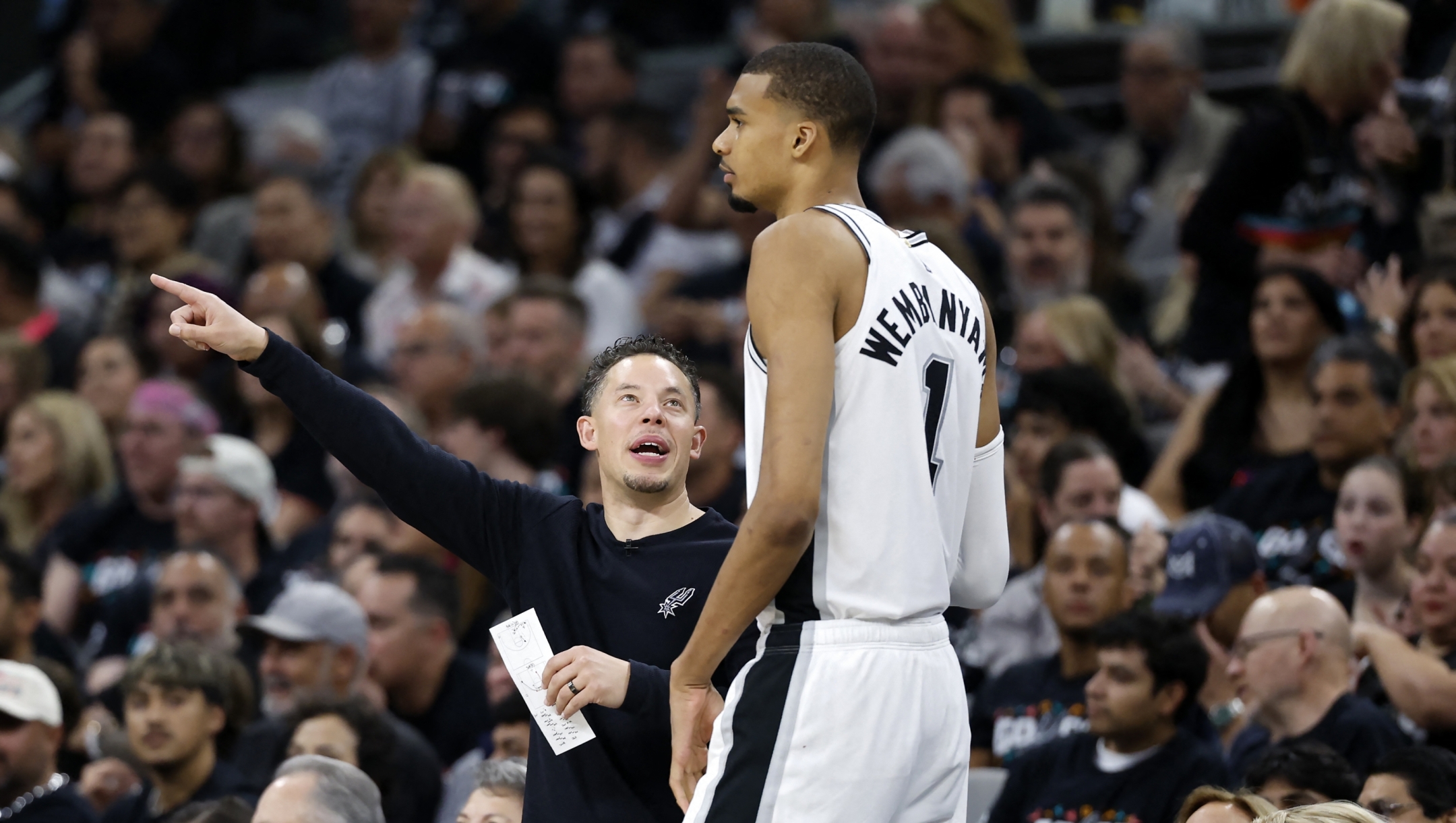  Head coach Mitch Johnson of the San Antonio Spurs speaks to Victor Wembanyama #1 during the third quarter against the Minnesota Timberwolves in Game Two of the Second Round of the NBA Western Conference Playoffs at Frost Bank Center on May 06, 2026 in San Antonio, Texas. NOTE TO USER: User expressly acknowledges and agrees that, by downloading and or using this photograph, User is consenting to the terms and conditions of the Getty Images License Agreement.   Ronald Cortes/Getty Images/AFP (Photo by Ronald Cortes / GETTY IMAGES NORTH AMERICA / Getty Images via AFP)