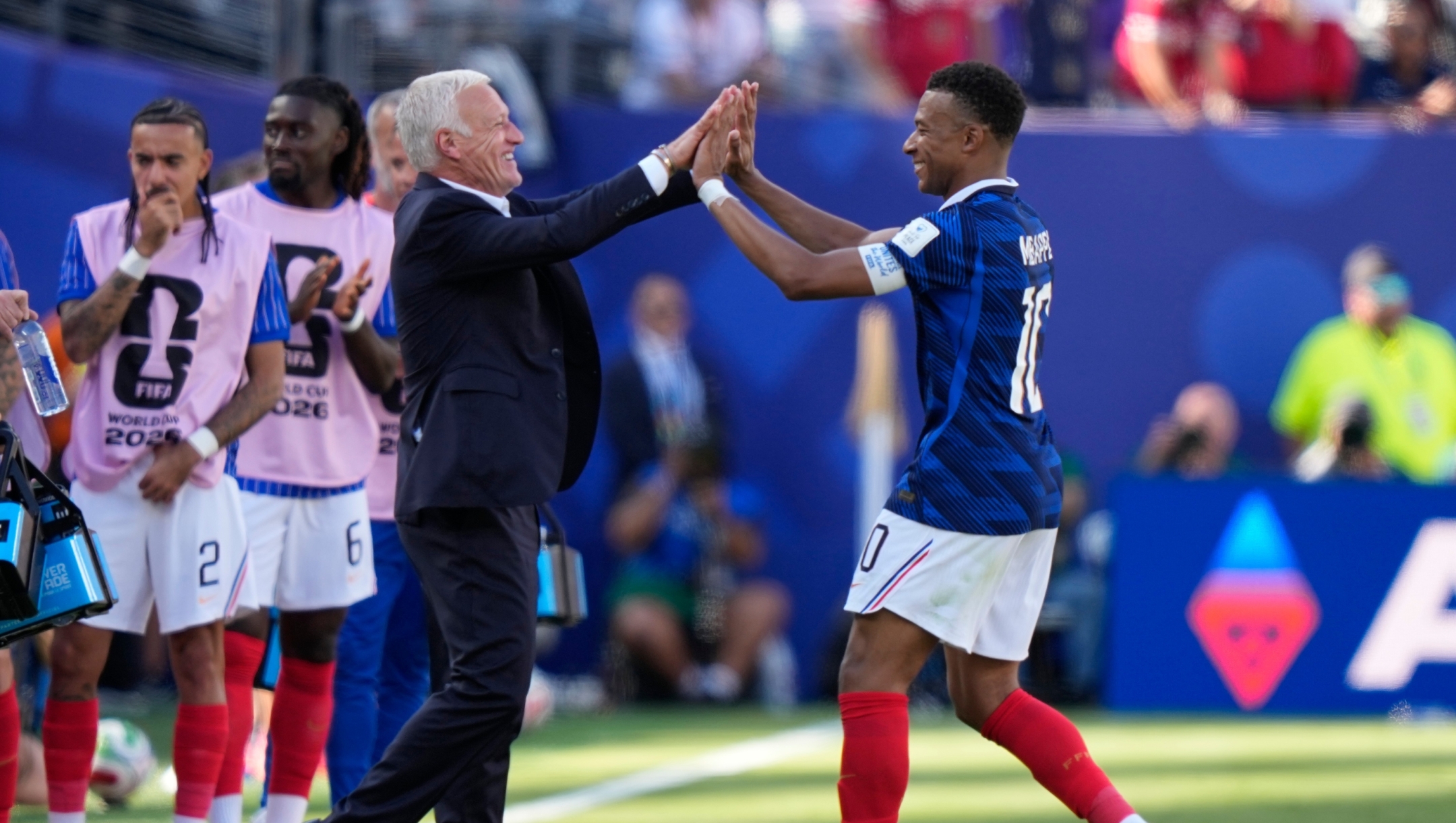 France's Kylian Mbappe, right, celebrates with France head coach Didier Deschamps after scoring his side's third goal during the World Cup Group I soccer match between France and Senegal in East Rutherford, N.J., near New York, Tuesday, June 16, 2026. (AP Photo/Frank Franklin II)