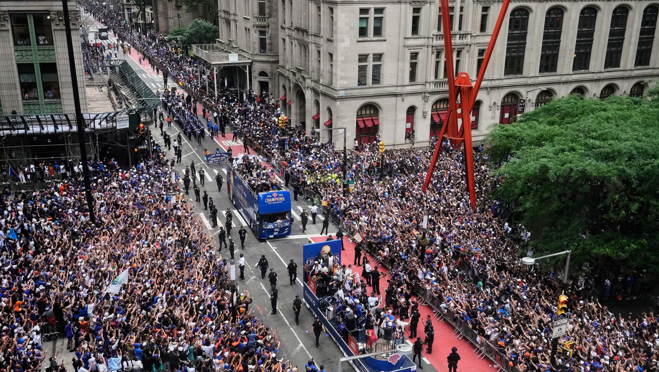Crowds fill the sidewalks for the NBA Champion New York Knicks ticker-tape parade in New York's "Canyon of Heroes," Thursday, June 18, 2026. (AP Photo/Richard Drew)