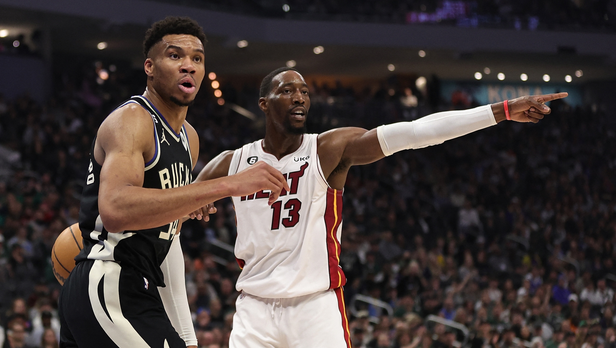  Giannis Antetokounmpo #34 of the Milwaukee Bucks and Bam Adebayo #13 of the Miami Heat react to an officials call during Game One of the Eastern Conference First Round Playoffs at Fiserv Forum on April 16, 2023 in Milwaukee, Wisconsin. NOTE TO USER: User expressly acknowledges and agrees that, by downloading and or using this photograph, User is consenting to the terms and conditions of the Getty Images License Agreement.   Stacy Revere/Getty Images/AFP (Photo by Stacy Revere / GETTY IMAGES NORTH AMERICA / Getty Images via AFP)