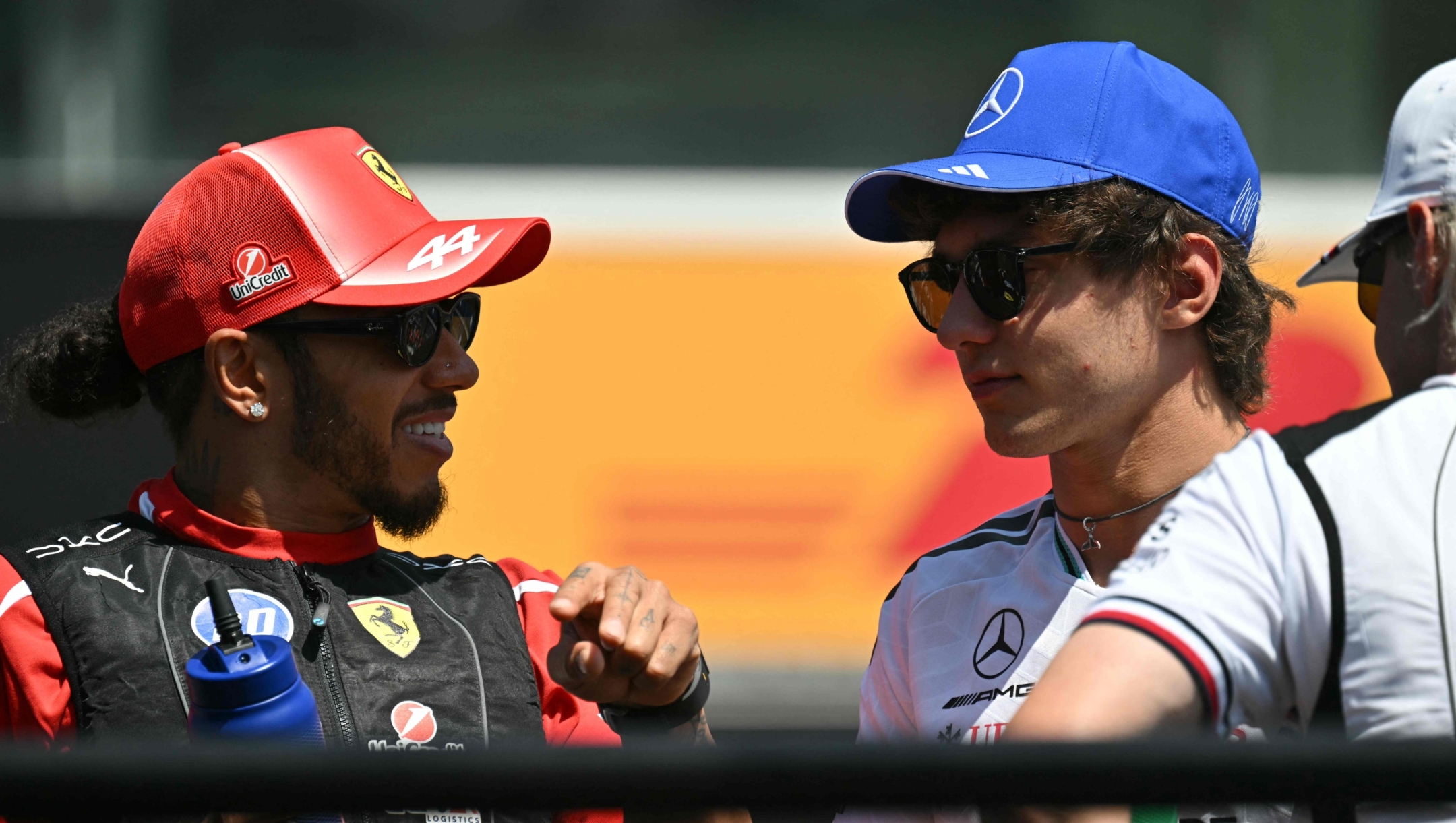 Mercedes' Italian driver Kimi Antonelli (R) speaks to Ferrari's British driver Lewis Hamilton during the drivers parade prior to the Formula One Hungarian Grand Prix at the Hungaroring racetrack in Mogyorod near Budapest, Hungary, on July 26, 2026. (Photo by Andrej ISAKOVIC / AFP)