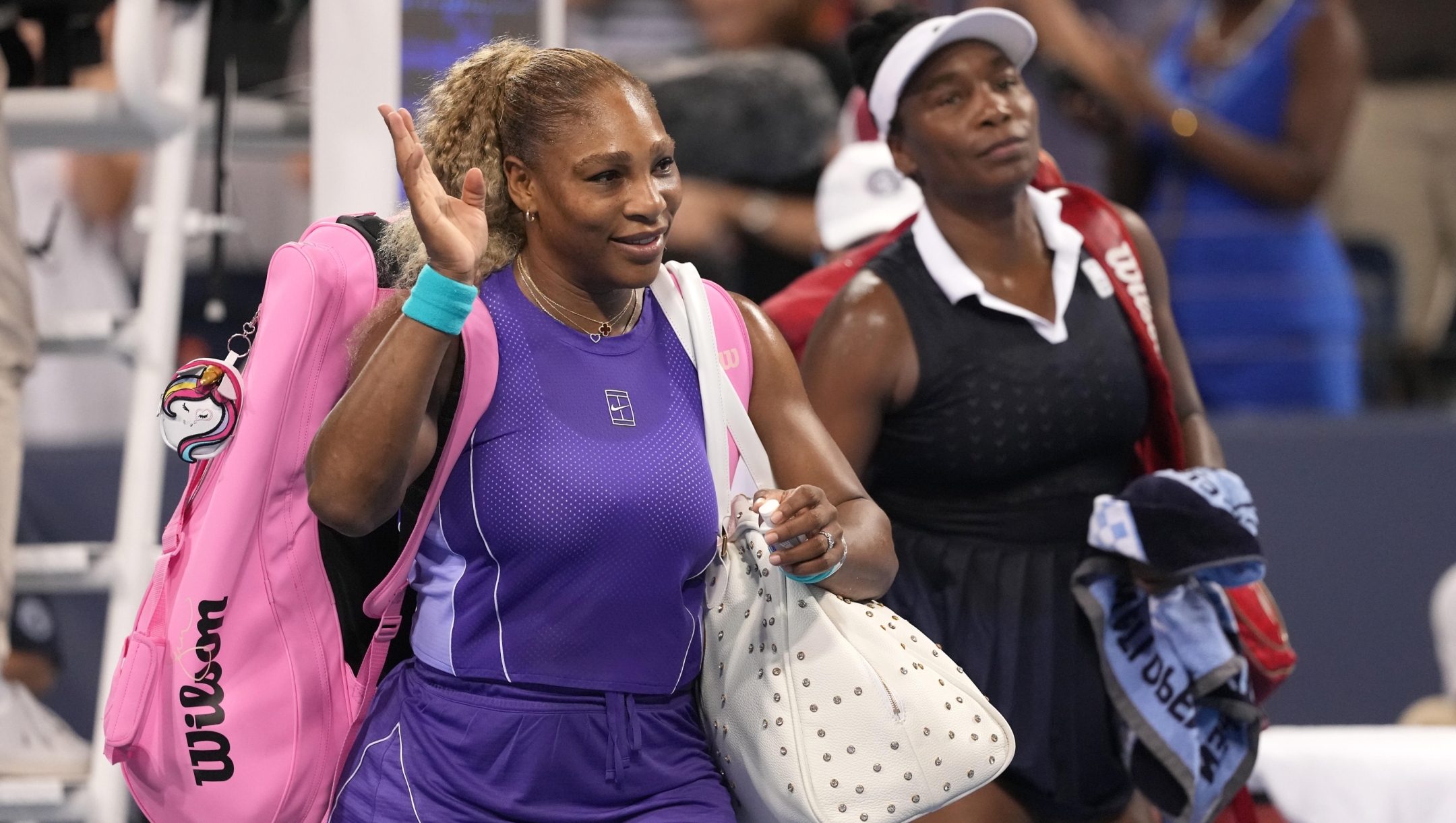 Serena Williams, left, and Venus Williams, right, both of the United States, wave to the crowd at the end of a women's doubles match against Marta Kostyuk, of Ukraine, and Peyton Stearns, also of the United States, at the Cincinnati Open tennis tournament, Monday, Aug. 17, 2026, in Mason, Ohio. (AP Photo/Kareem Elgazzar)