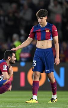 BARCELONA, SPAIN - APRIL 16: Ilkay Guendogan of FC Barcelona is consoled by teammate Pau Cubarsi after the team's defeat in the UEFA Champions League quarter-final second leg match between FC Barcelona and Paris Saint-Germain at Estadi Olimpic Lluis Companys on April 16, 2024 in Barcelona, Spain. (Photo by David Ramos/Getty Images)