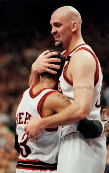 The Philadelphia 76ers' Allen Iverson (L) is hugged by teammate Matt Geiger (R) late in the second period of the fourth game in the first round of the Eastern Conference playoffs 01 May 2000 at the First Union Center in Philadelphia. The 76ers won 105-99 and now advance to the next round of the NBA Playoffs. Iverson had 26 points. AFP PHOTO/Tom Mihalek (Photo by TOM MIHALEK / AFP)